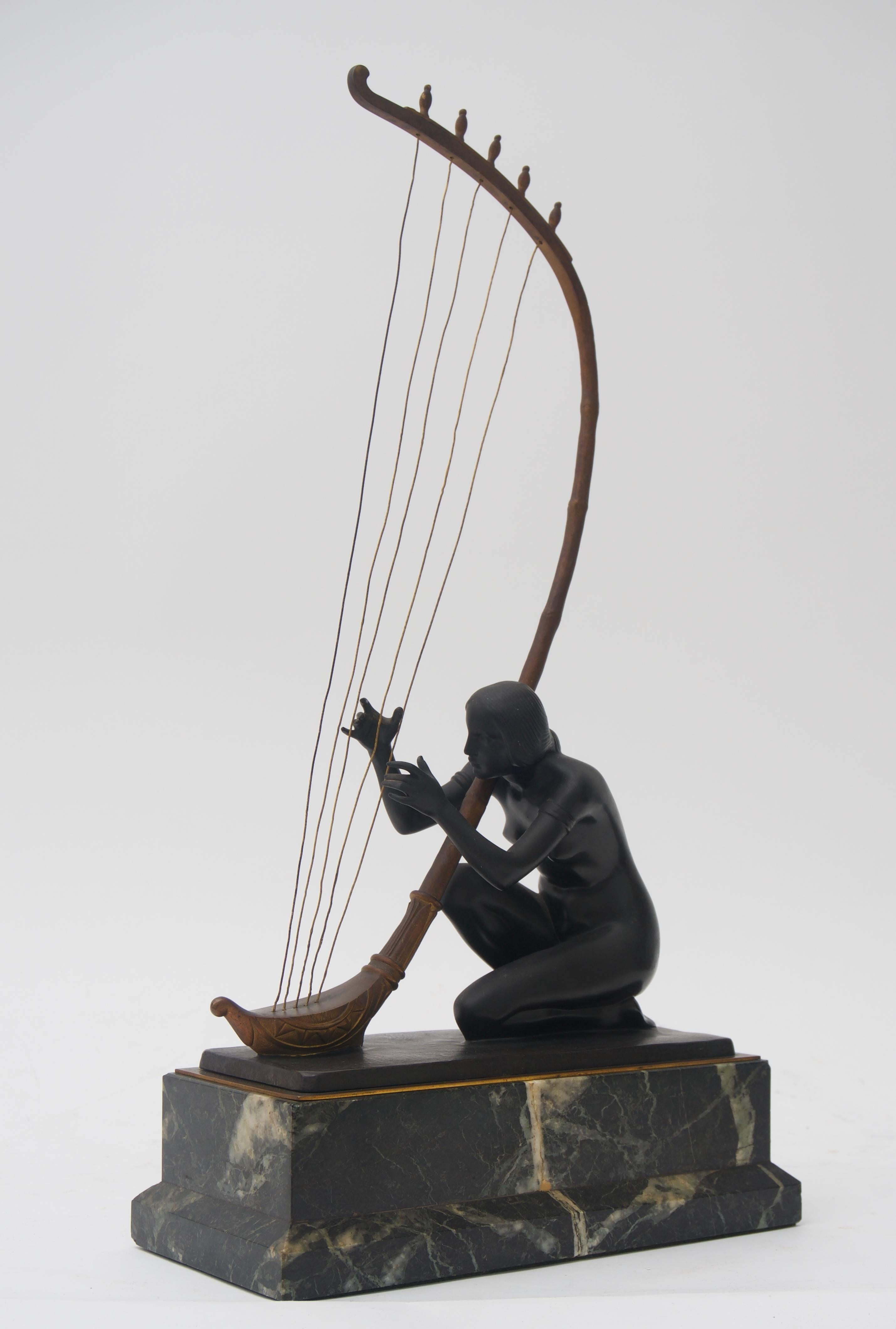 This piece was acquired from a Palm Beach collection and is by the Austrian sculptor Hans Muller. Here Muller has captured a nude maiden playing a stringed instrument as to beckon us with an alluring sound and memories.

This piece has tones of