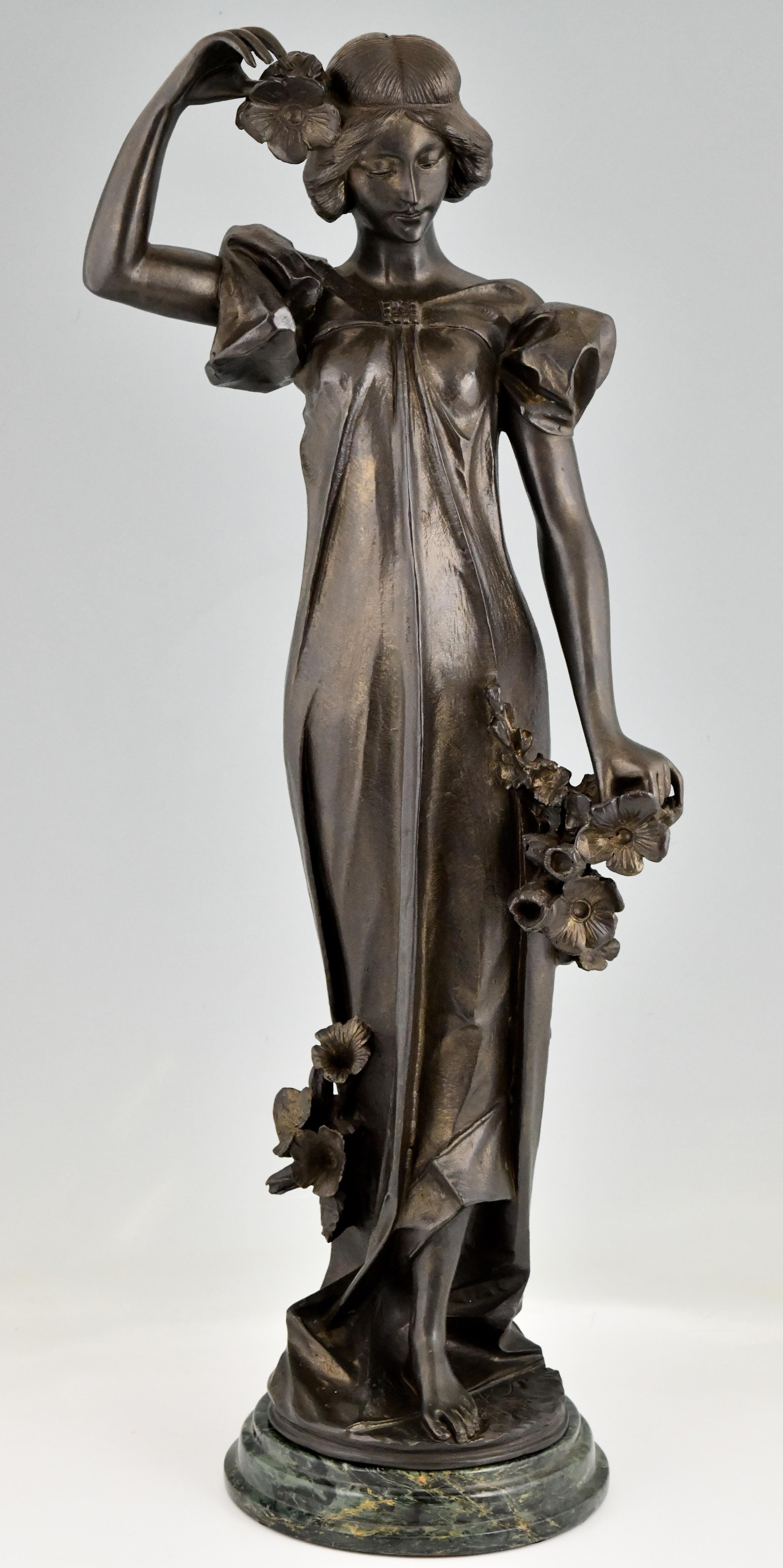 Art Nouveau bronze sculpture lady with poppies signed by Adolpho Cipriani
Patinated bronze on a green marble base. 
Cipriani was an Italian artist who worked in France. 
Ca. 1900. 
Weight 25 KG. 