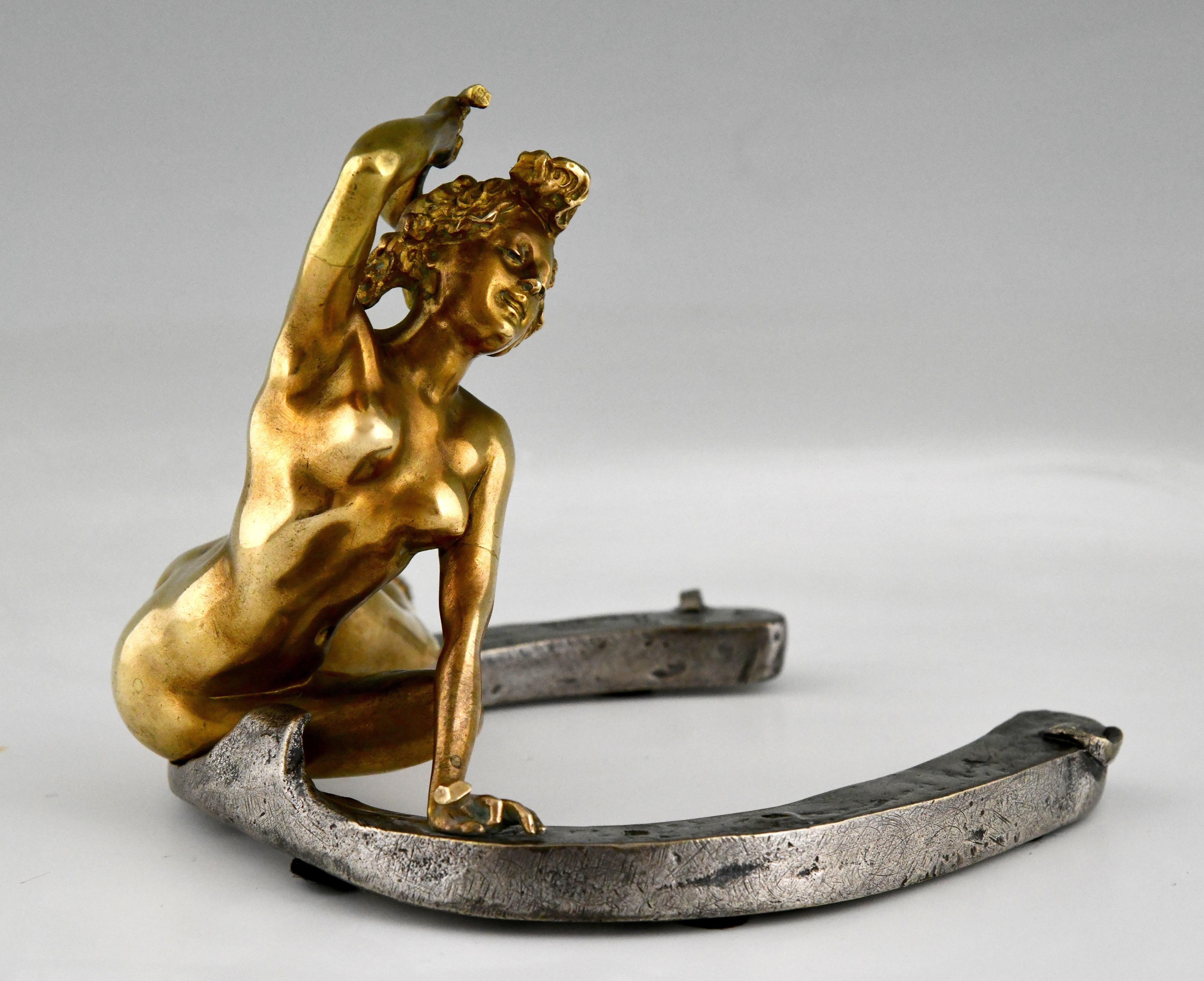 Art Nouveau bronze sculpture nude on a horseshoe by Georges Récipon, foundry mark Susse frères foundry. Gilt en patinated bronze. France 1896. This is the large version of this model.

This model is illustrated in Dynamic Beauty, Maclowe Gallery.