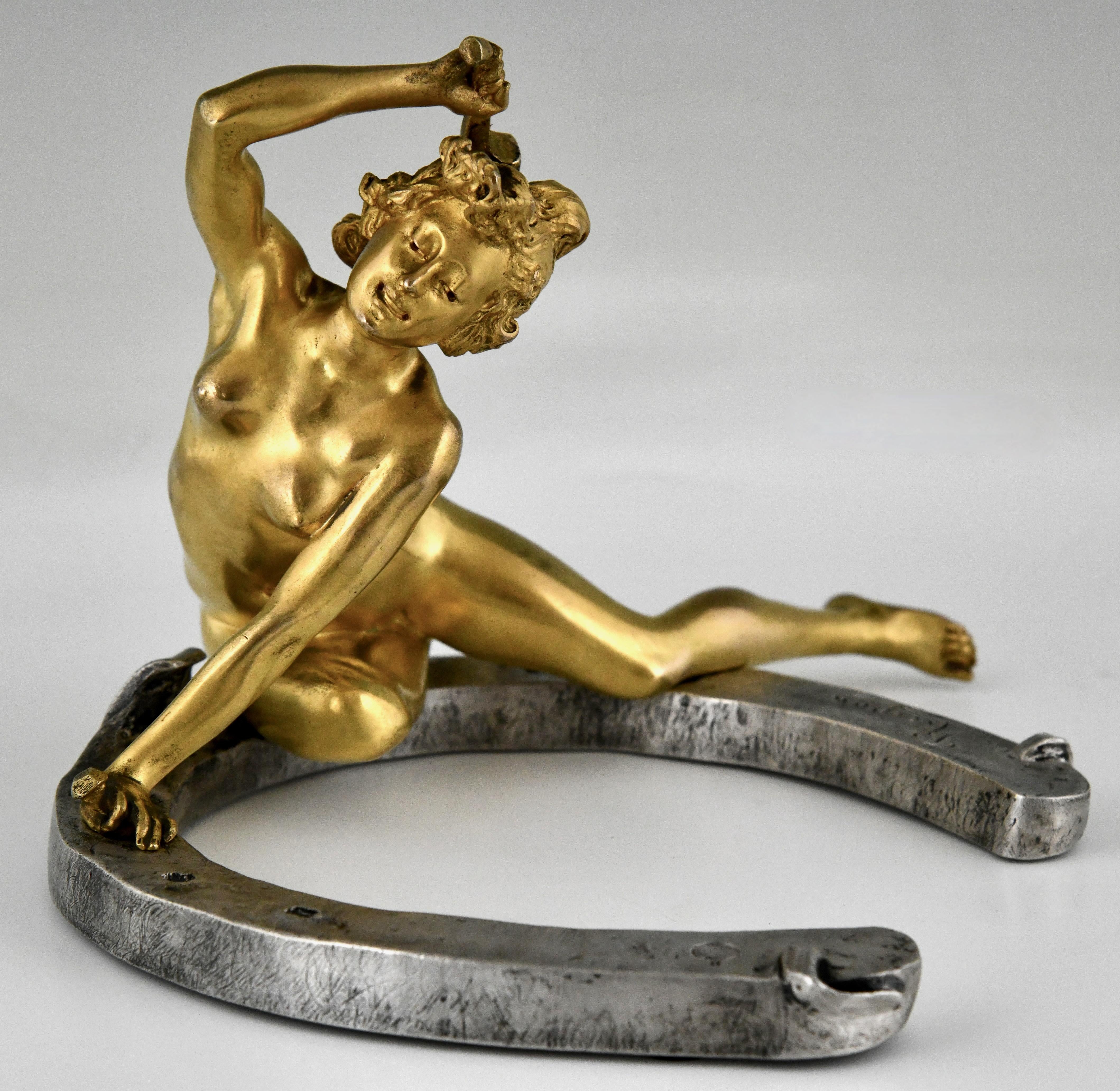 Art Nouveau bronze sculpture nude on horseshoe by Georges Récipon, foundry mark Susse frères foundry. 
Gilt en patinated bronze.
France 1896. 
This is the large version of this model.
With COA. 

This model is illustrated in
Dynamic Beauty,