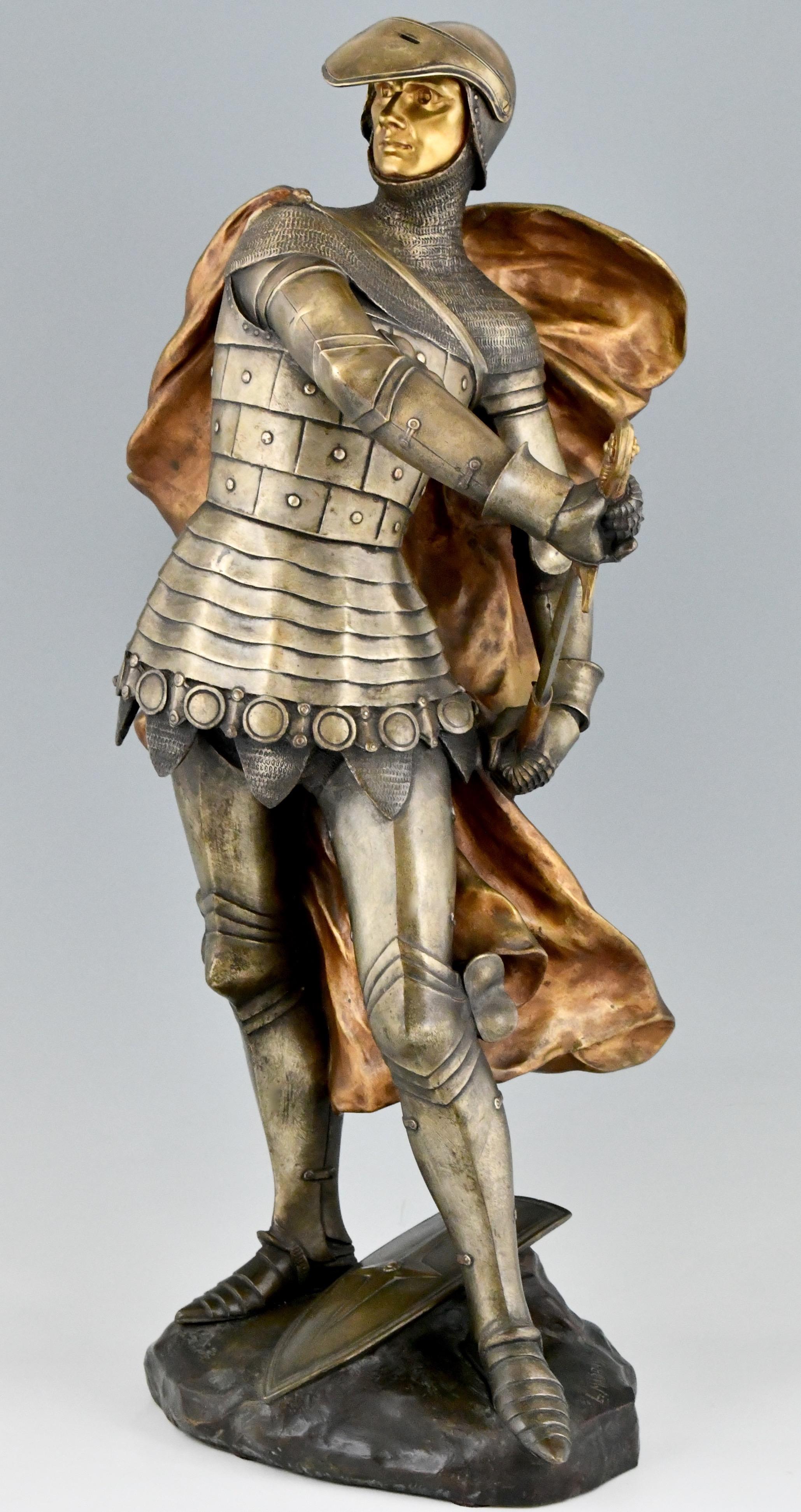 Impressive bronze Art Nouveau sculpture of a knight in armor with cloak by Lucas Madrassi, France, ca. 1900.
The sculpture has a beautiful patina in silver and gold. 

Literature:
“Etains 1900” Philippe Dahan, les éditions de l'amateur. ?“The