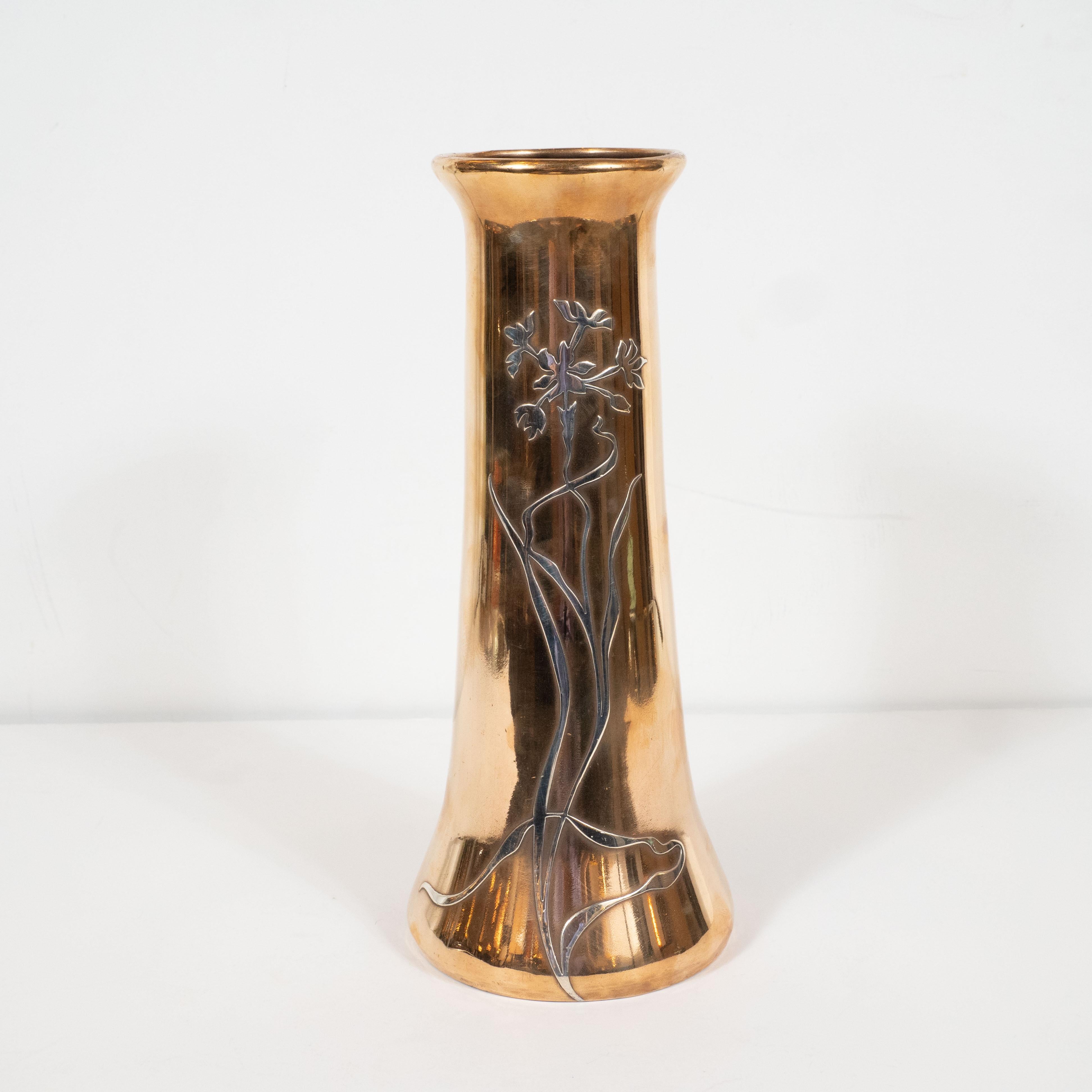 This vase was designed and handcrafted by the artisans at Heintz Art Metal Shop circa 1915. hand forged in lustrous bronze, the vase has a conical shape with a flared base and lip. A delicately articulated allium with a sinuously curved stem and