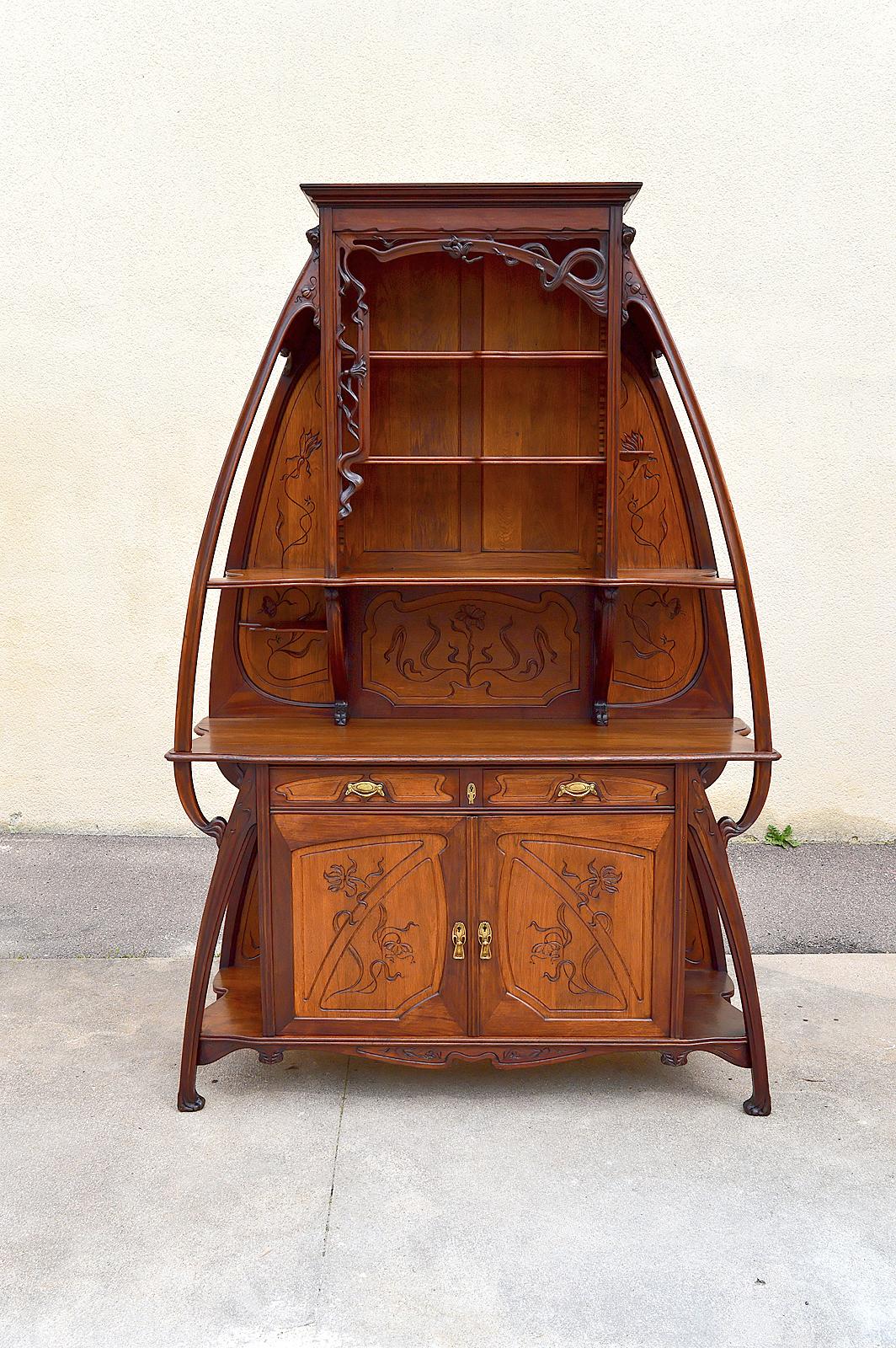 Sublime sideboard / cabinet / buffet two asymmetrical bodies and richly carved with flowers.

The free form of the sideboard and the work in wood and bronzes are typical of early Art Nouveau.

Mahogany structure, oak panels.
Bronze handles and