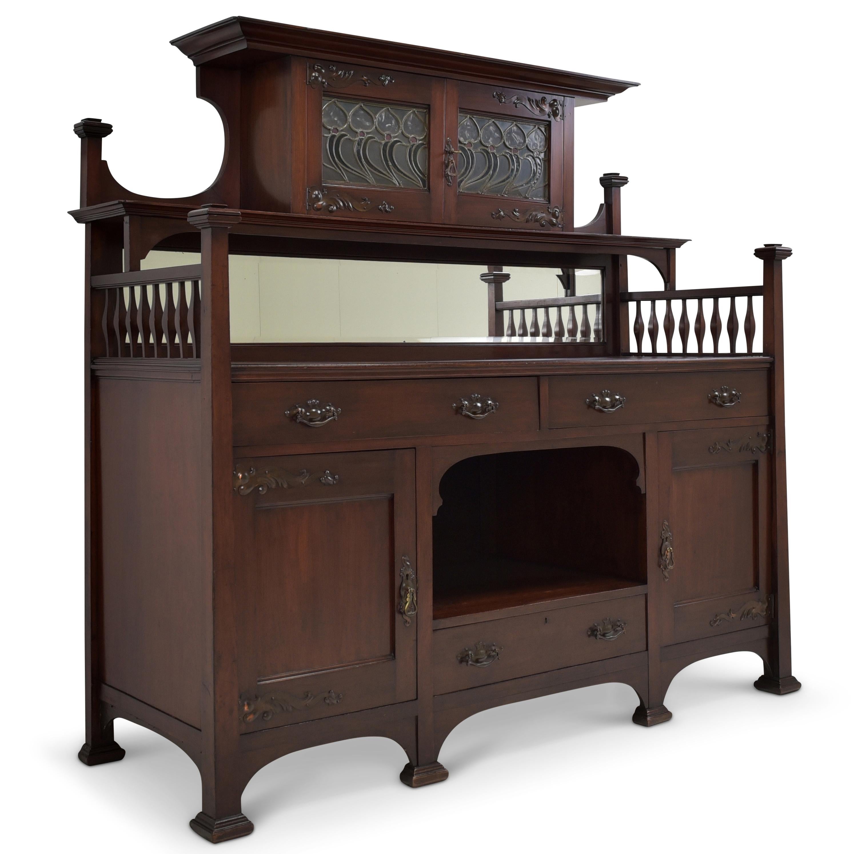 Buffet cabinet restored Art Nouveau circa 1900 mahogany credenza sideboard

Features:
Wide base with low, tapered top
Very high quality processing
Drawers pronged
High-quality original fittings
Original Art Nouveau stained glass with a few