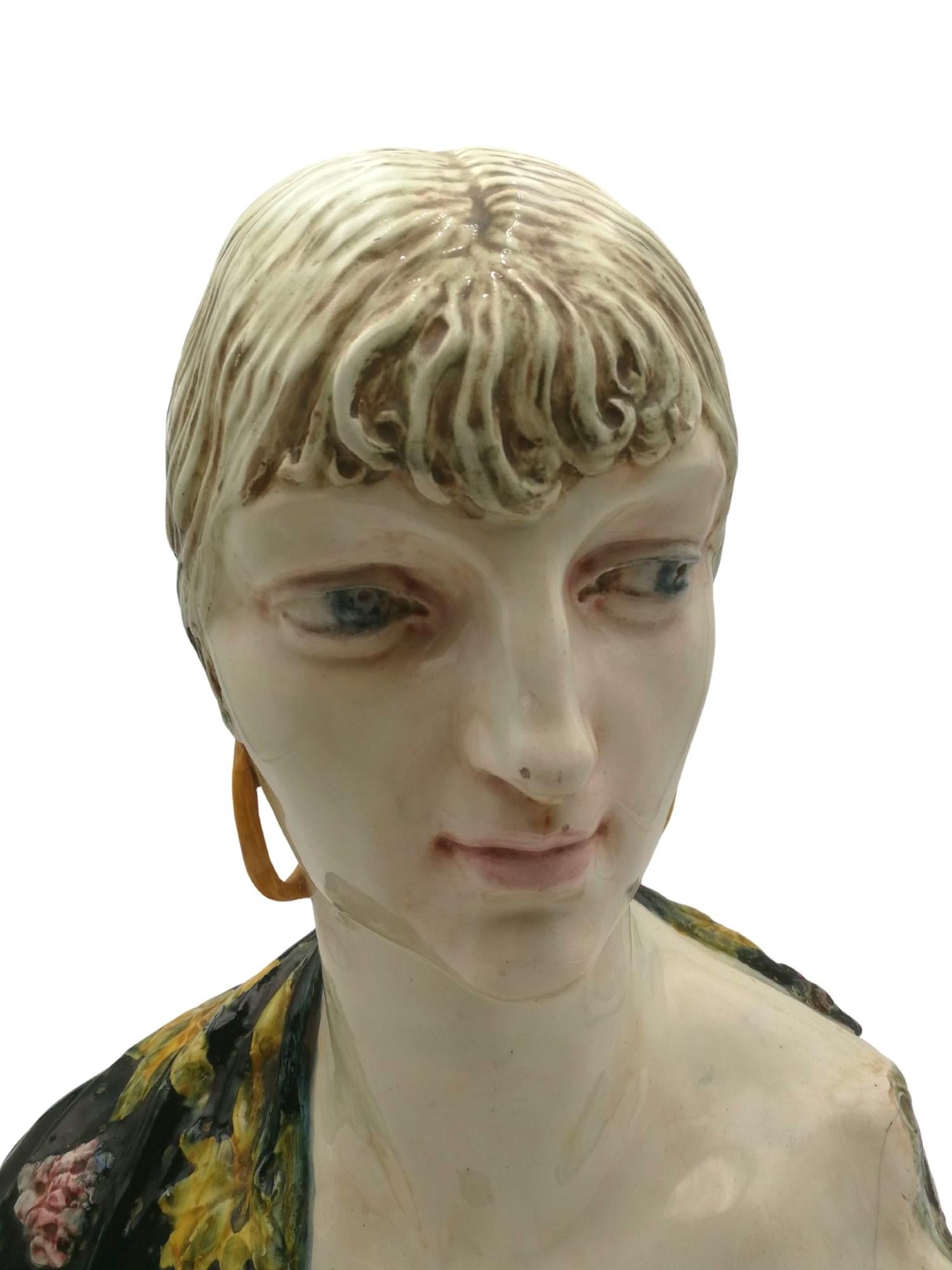 Stunning and appealing Art Nouveau bust of a woman made of polychromed and enamelled white clay. This singular bust of a woman with unique face traits could be of an Italian woman, maybe from Sicily, or even a Spanish gipsy.
Origin: Unknown,