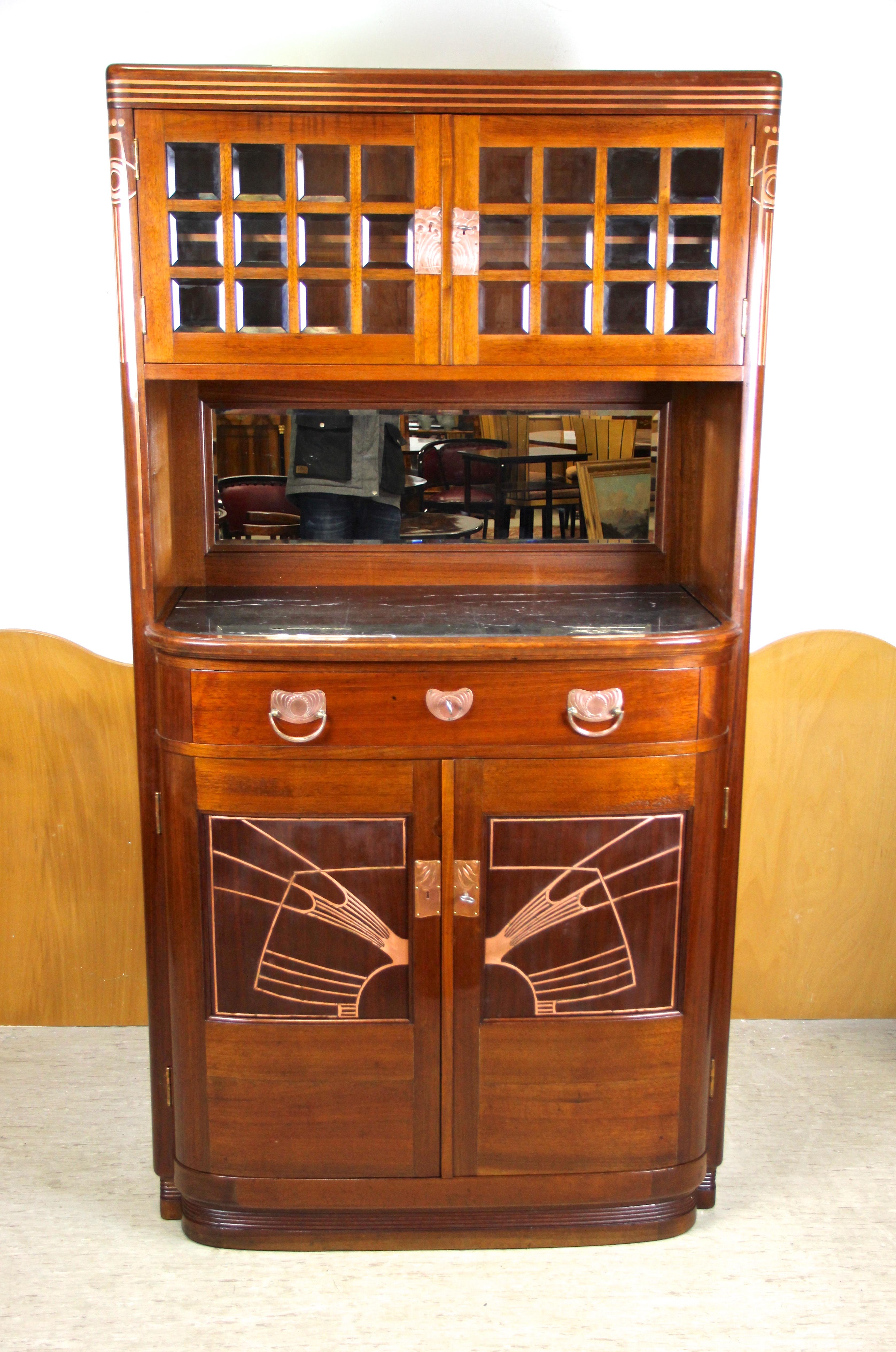 Mesmerizing Art Nouveau cabinet or buffet by August Ungethüm from Austria, circa 1900. Designed and produced by the famous art furniture factory of A. Ungethüm in Vienna, the fine mahogany buffet stands out with a very unique design. The upper part