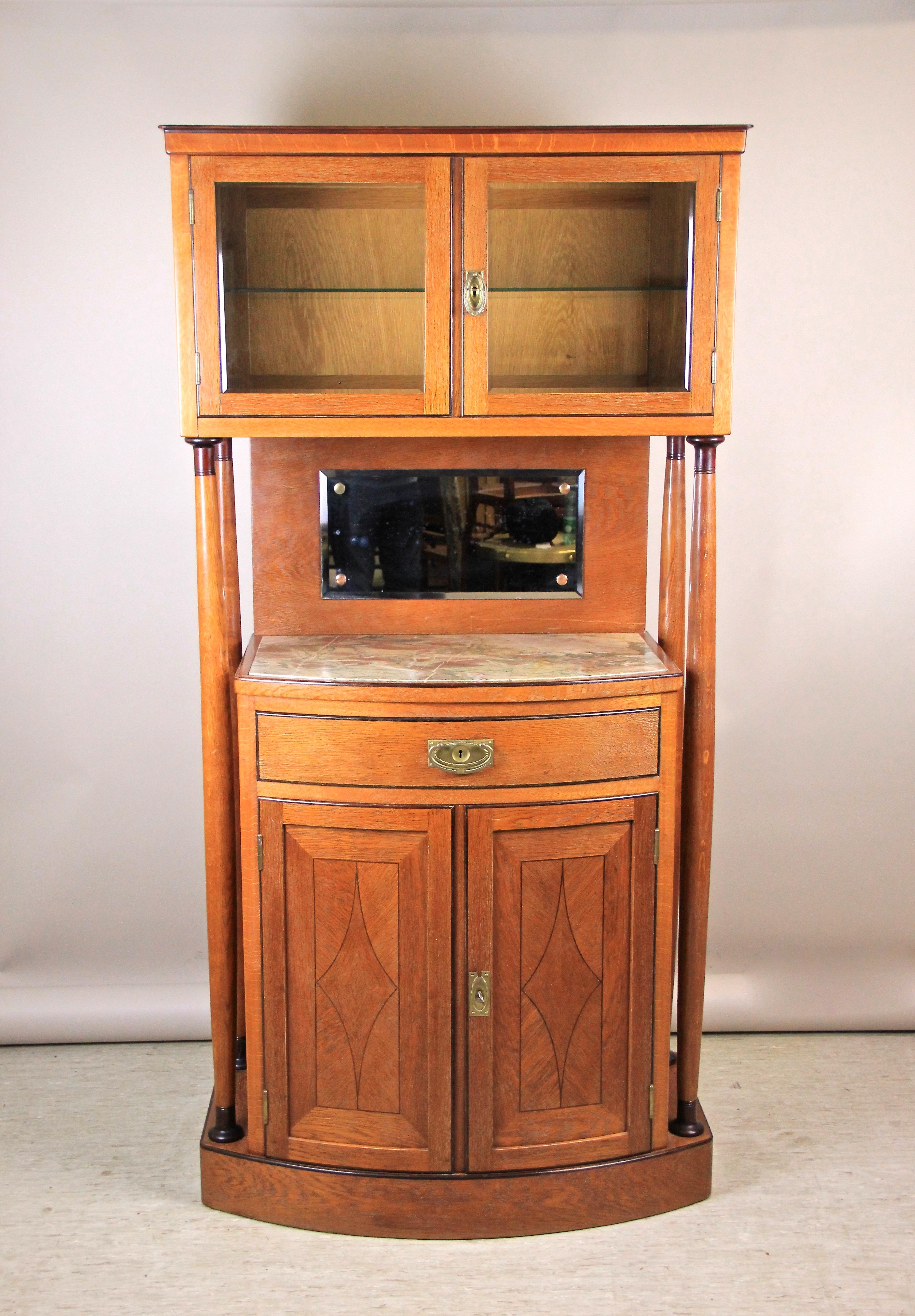 Extraordinary Art Nouveau cabinet/ buffet originating from Austria, circa 1915. The lower part with one drawer and two doors shows a wonderful convex shaped design. The upper part, providing a smaller compartment behind two glass-panelled doors,
