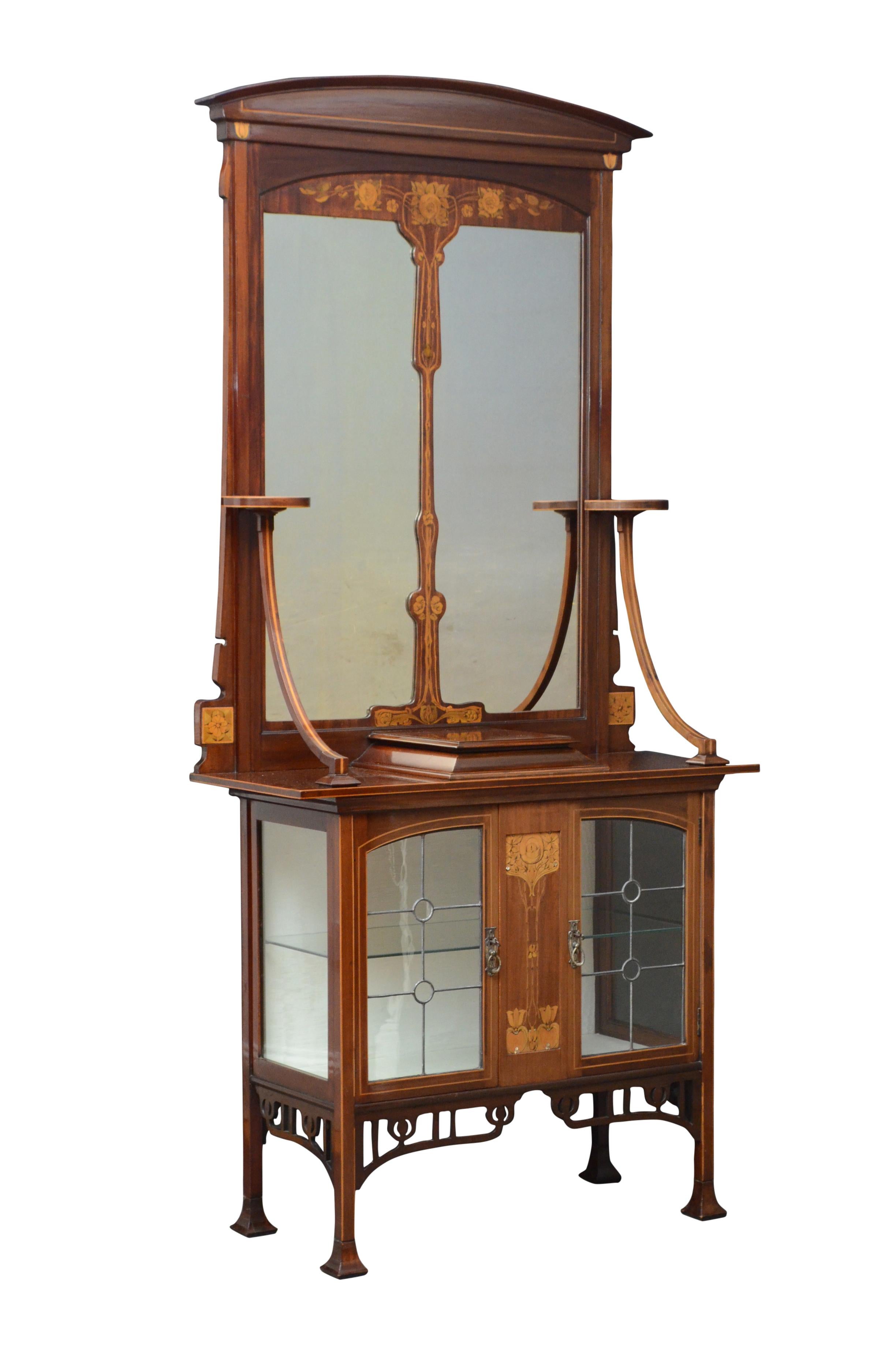 K0450 stylish Art Nouveau mahogany and marquetry hall cabinet with arched cresting above divided mirror flanked by a pair of circular platforms on downswept supports, the projecting base having floral inlaid centre panel, outlined in boxwood and