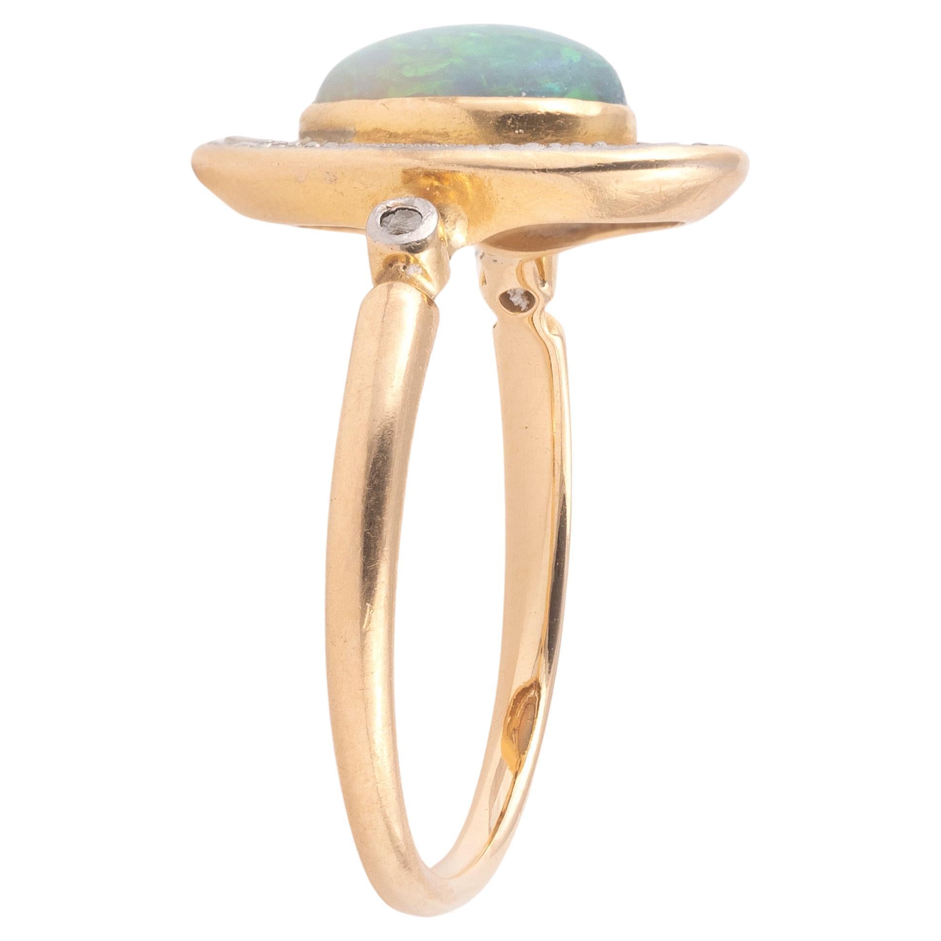 18K yellow gold and platinum ring set with an opal cabochon cluster rose diamond
Opal dimensions: 10mm x 6mm x 2.5mm
Size 7
Weight: 2,8 gr