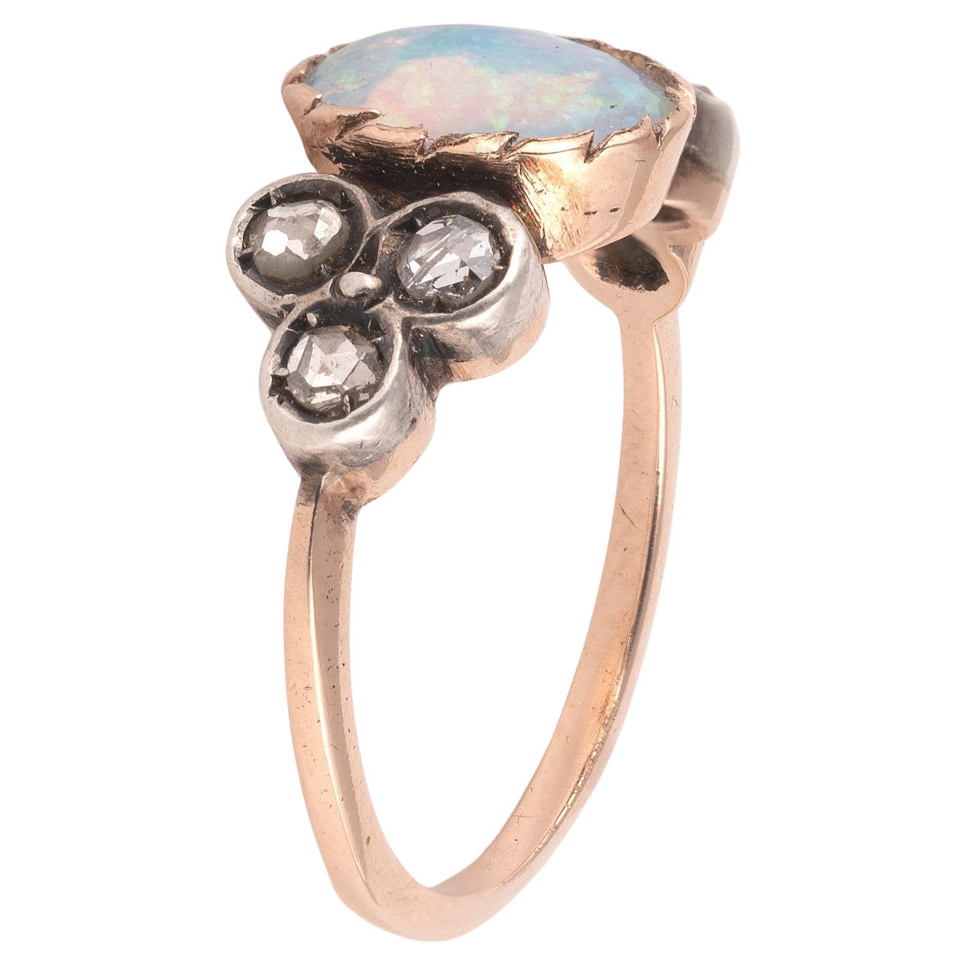 18K yellow gold and silver ring set with an opal cabochon cluster rose diamond
Opal dimensions: 10mm x 6mm x 2.5mm
Size 7
Weight: 2,8 gr

