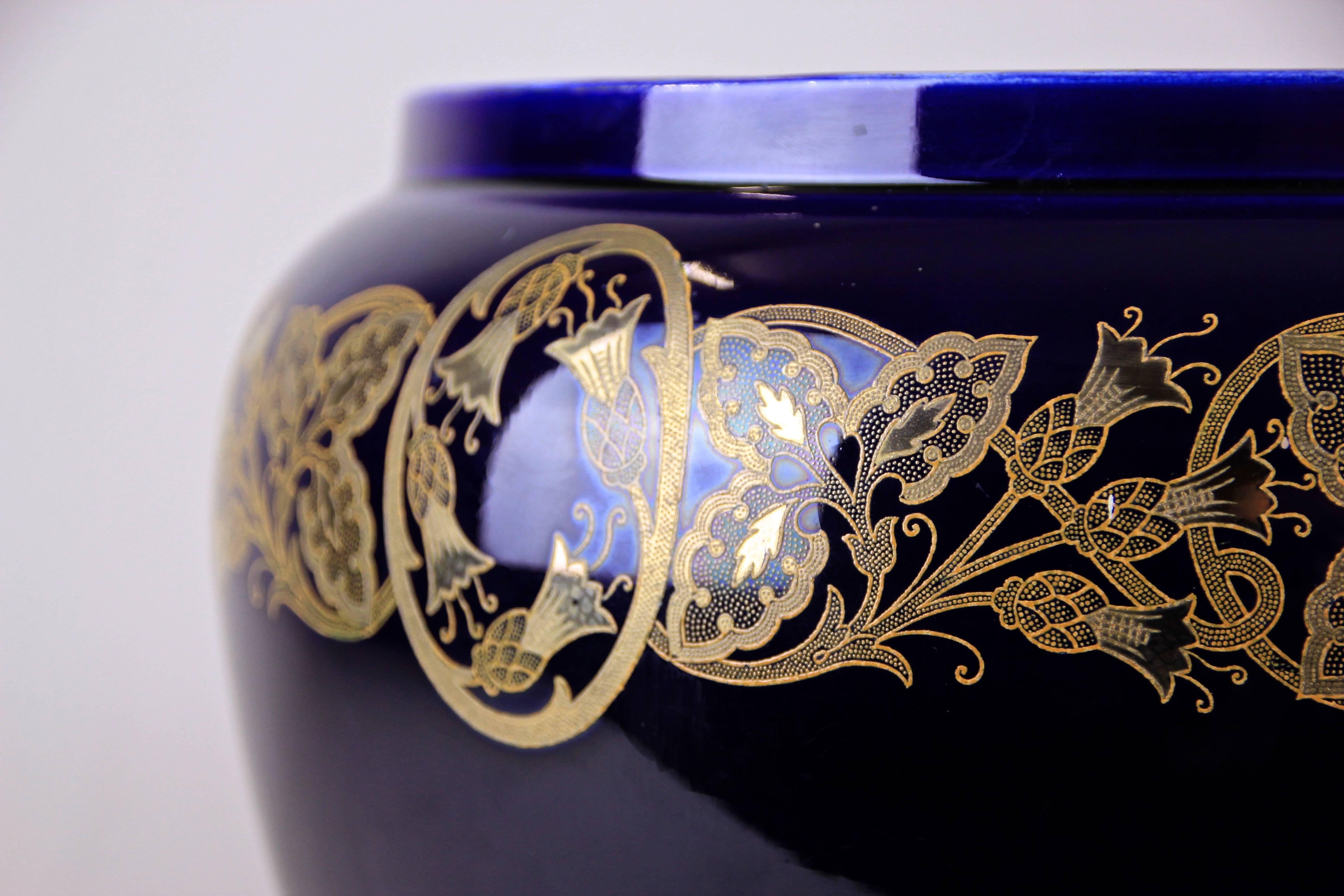Very decorative Art Nouveau cachepot by Sarreguemines France, circa 1915. The marvellous floral design shows beautiful tendrils and flowers hand-painted with gold color. In combination with the dark cobalt blue color a lovely contrast.
On the