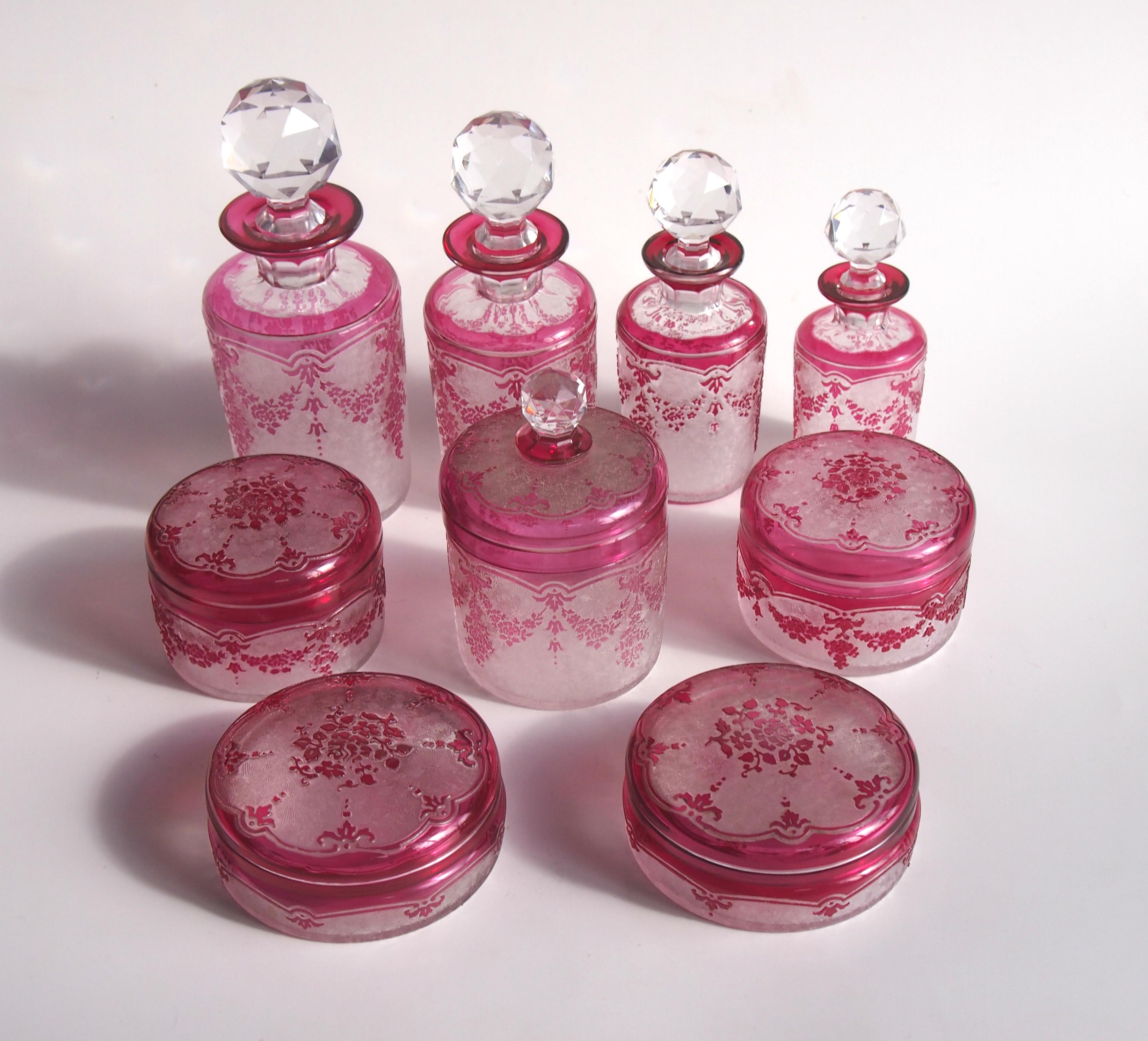 Amazing Art Nouveau Val Saint Lambert red on clear cameo glass 9-piece dressing table set -Including 4 different sized scent bottles with facet cut stoppers, 2 low lidded boxes, 2 taller lidded boxes and a larger box and cover with a knob to the lid