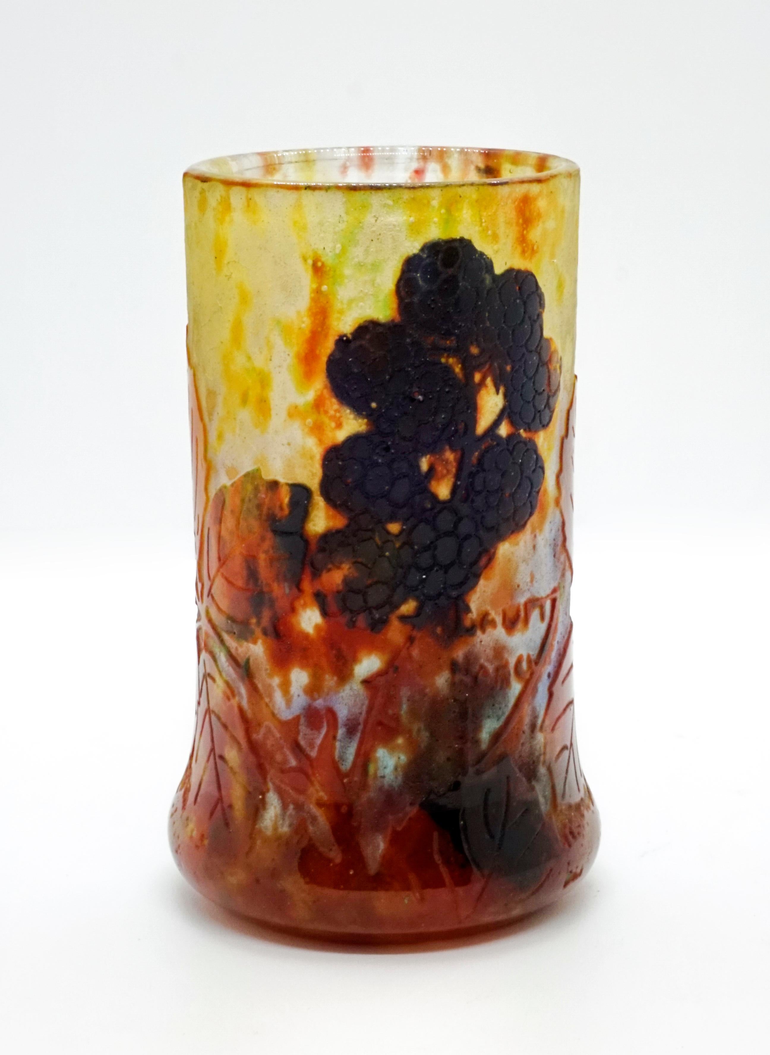 Cylindrical vase, colorless glass with flaky yellow-green, rust-red and blackberry-colored powder melts, overlaid in several layers, blackberry and leaf motifs worked out in high cut, satined, structured surface, relief signature 'Daum Nancy' with