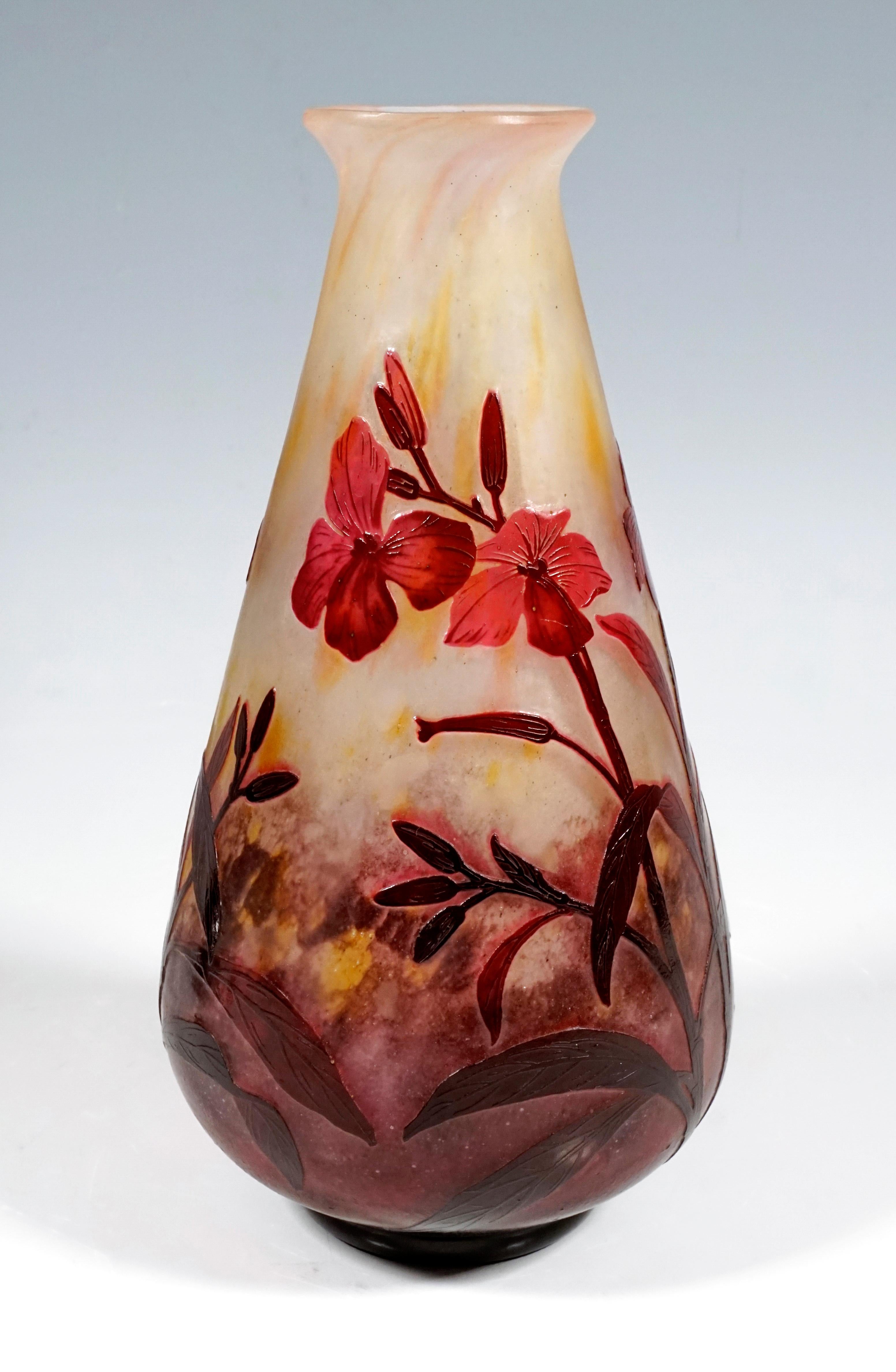 Conical shaped vase with flared, rounded mouth rim, colorless glass with flaky white, yellow and red-violet powder melts, burgundy-magenta-colored overlay, high-cut dames-wort flowers decor, satined surface in the background, relief signature 'DAUM