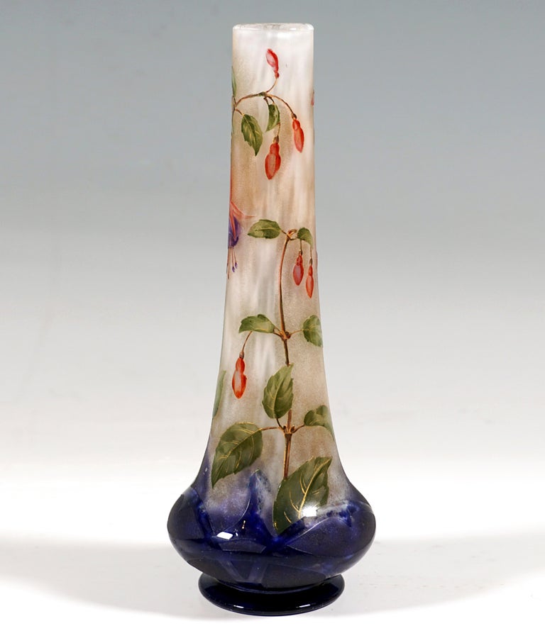 Slender vase on a stepped, round base, flat, bulbous extension above the constriction, raised and converging to a slender neck, colorless glass with flaky white, in the base area with royal blue color powder inclusions, with etched and painted in