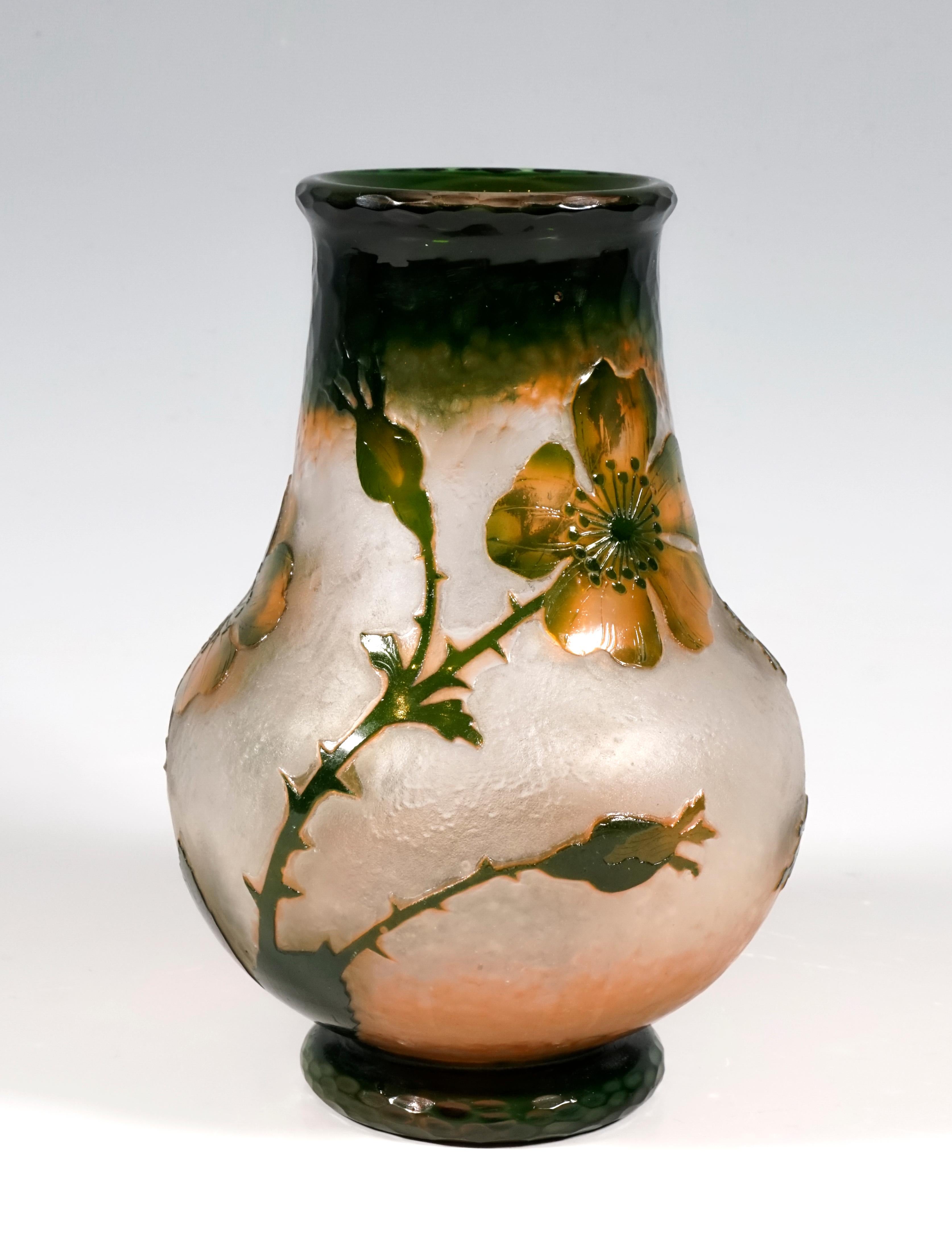 Vase in a bulbous shape with an offset round base, wide neck that tapers towards the top with a slightly flared mouth rim, colorless glass with a milky, opaque inner melting’s in the lower area, dark green and orange to rose-colored melting’s in the