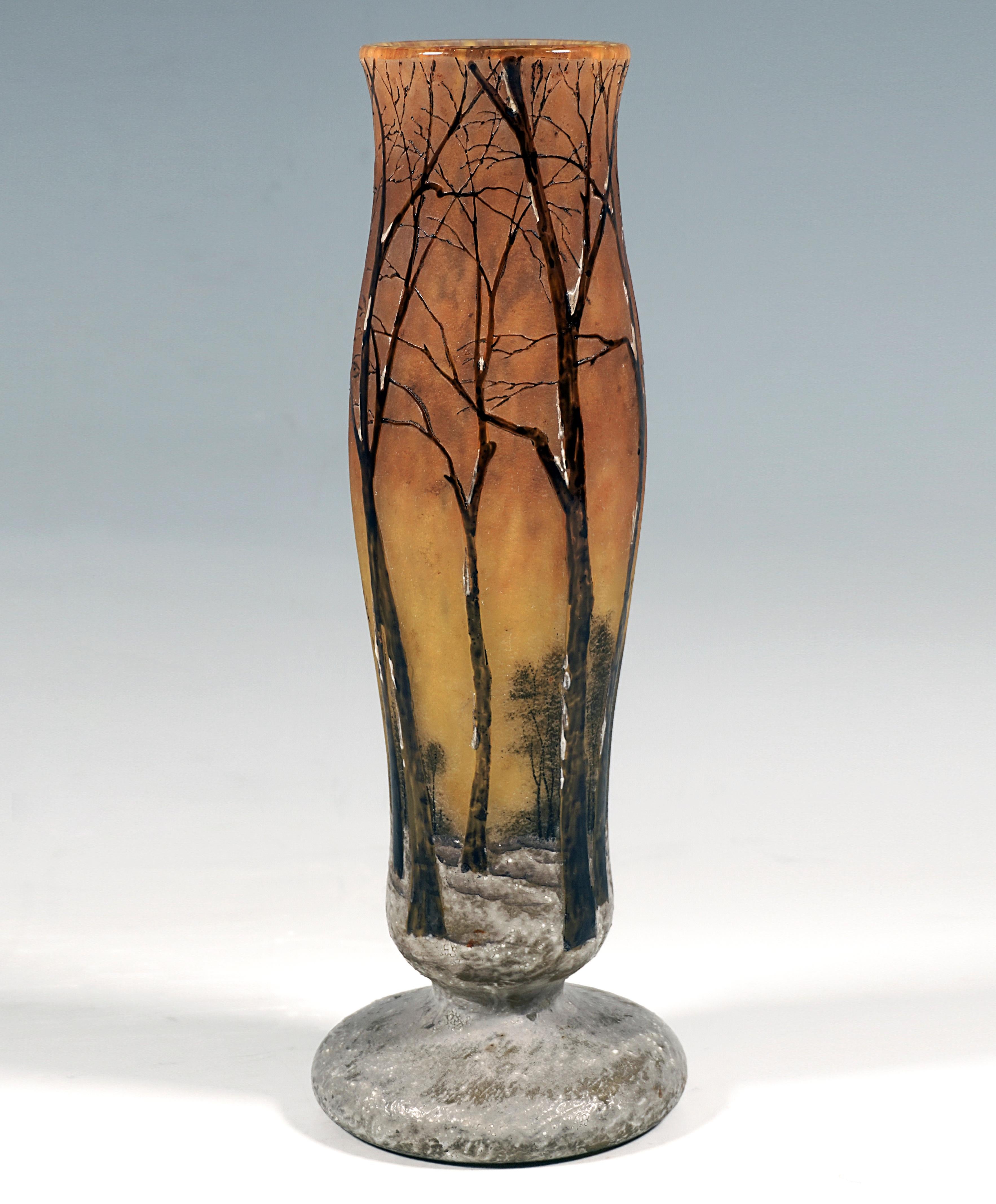 Slender baluster vase on a separate base, colorless glass with flaky yellow powder inclusions, overlay in brownish orange and yellow, in the lower area in gray and white, winter landscape etched in several stages and finely painted with colored