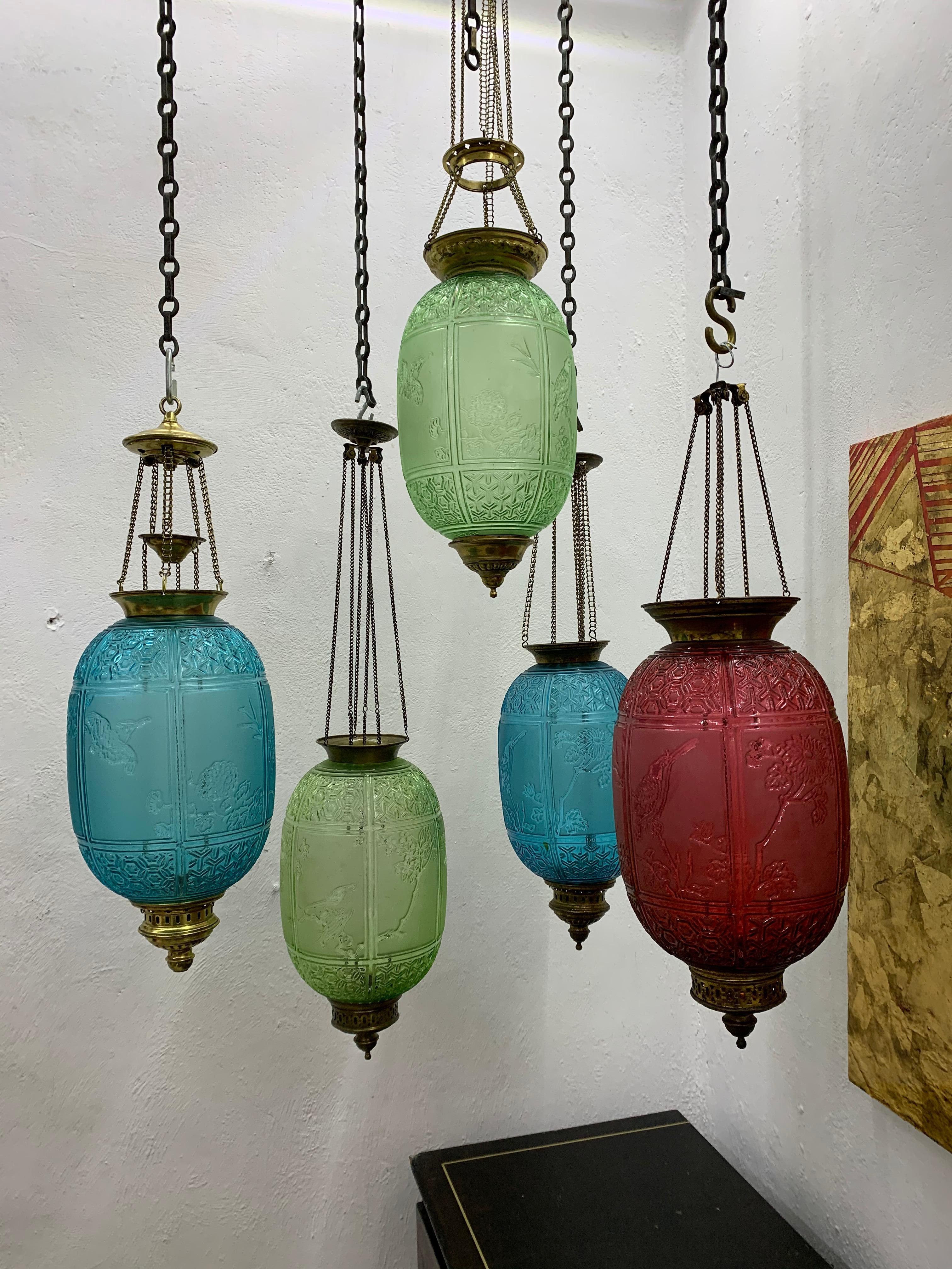 Two Green, late 19th or early 20th century glass Lanterns by Baccarat France, both  signed in the bottom with Baccarat and Depose marks.
They are in clear art nouveau / orientalist taste, depicting 3 panels with different birds as well as panels