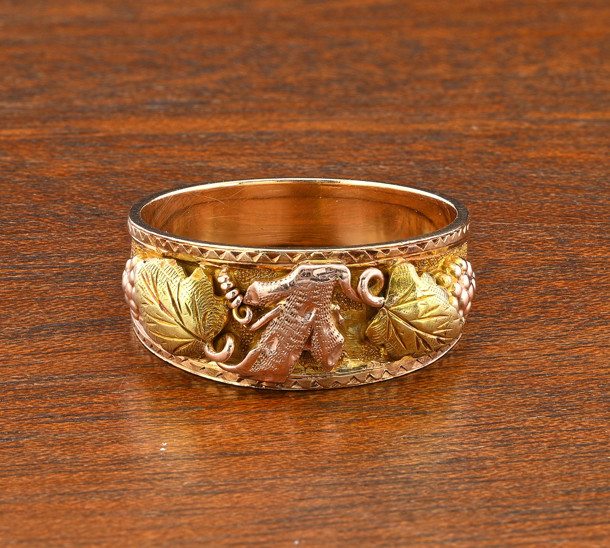 This beautiful and quite unique antique band ring is Art Nouveau period 1905 circa
Artful hand crafted of solid 14 Kt rose and yellow gold
Front side skillfully 3D hand carved featuring grape shoots and sinuous ivy leaf with gorgeous frame detailing
