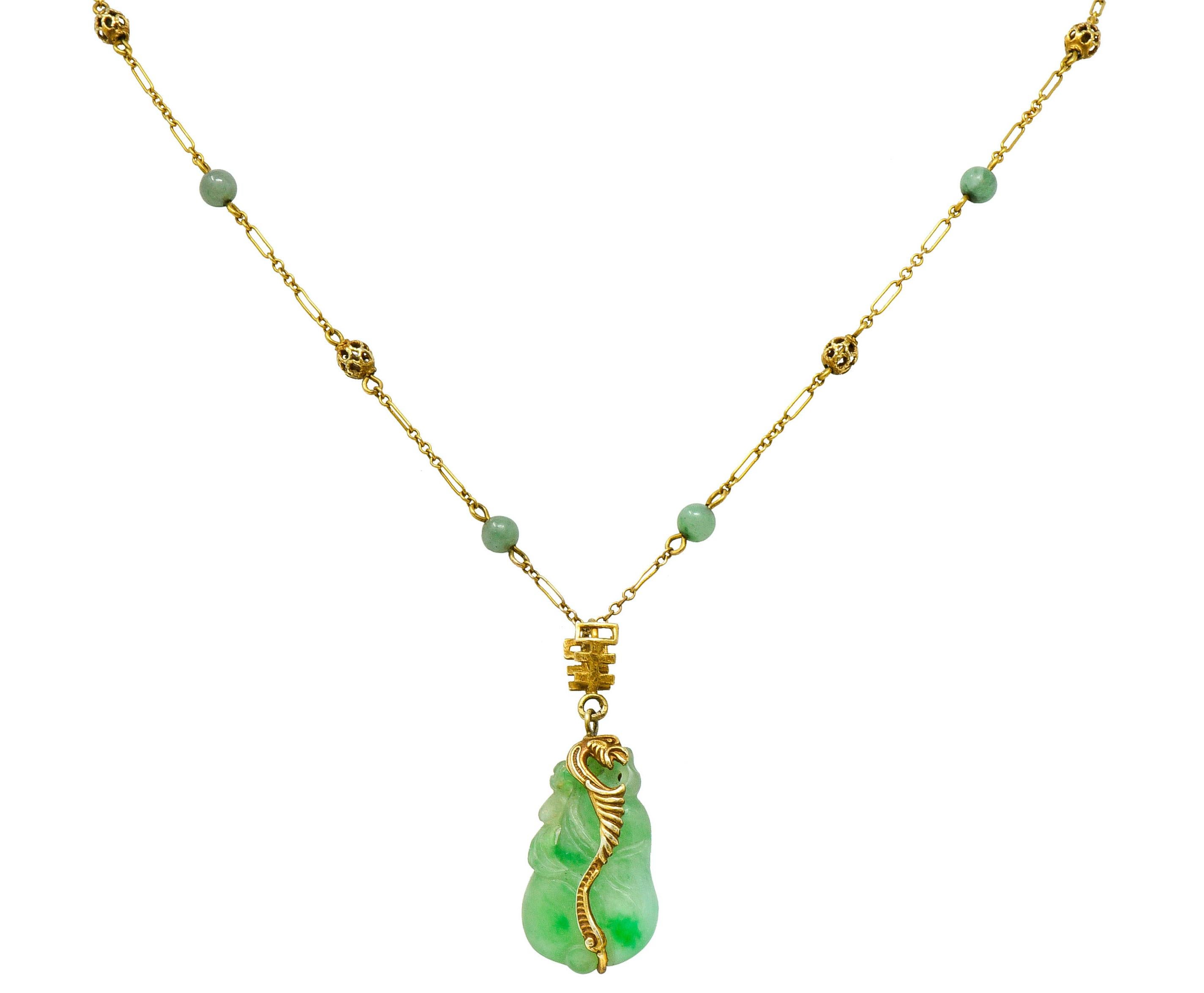 Paperclip style chain necklace is accented by 4.0 mm gold ball and 4.2 mm jade ball stations throughout

Suspending a drop of carved jade, translucent with natural veining, and strongly light green to green in color

Affixed to necklace by a gold