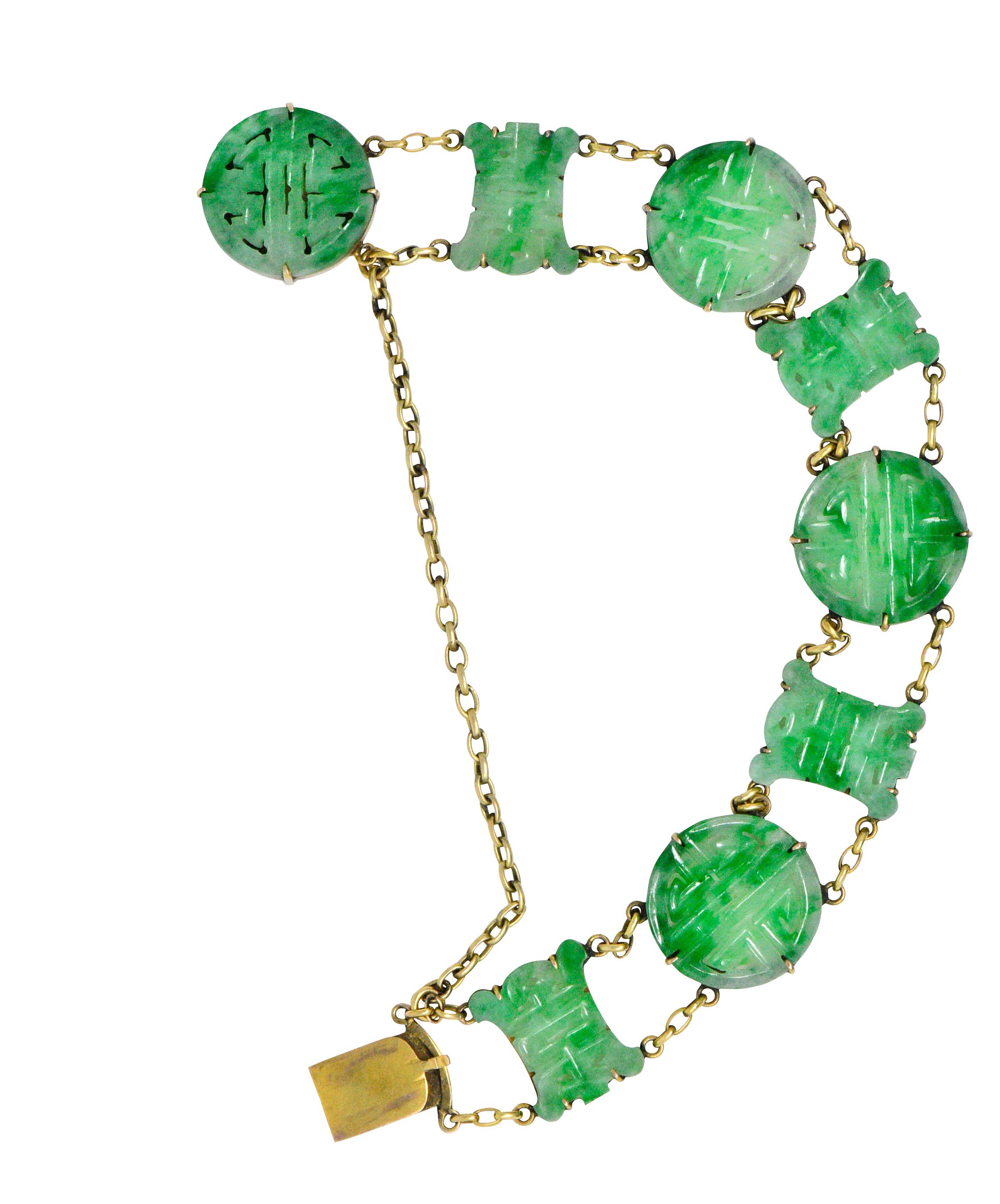 Featuring 8 carved jade links, 4 depicting the round symbol for shou, meaning longevity and 4 portraying the symbol for happiness

Bright mottled green, well matched 

Connected by cable style chains tested as 14k gold

Concealed clasp with safety