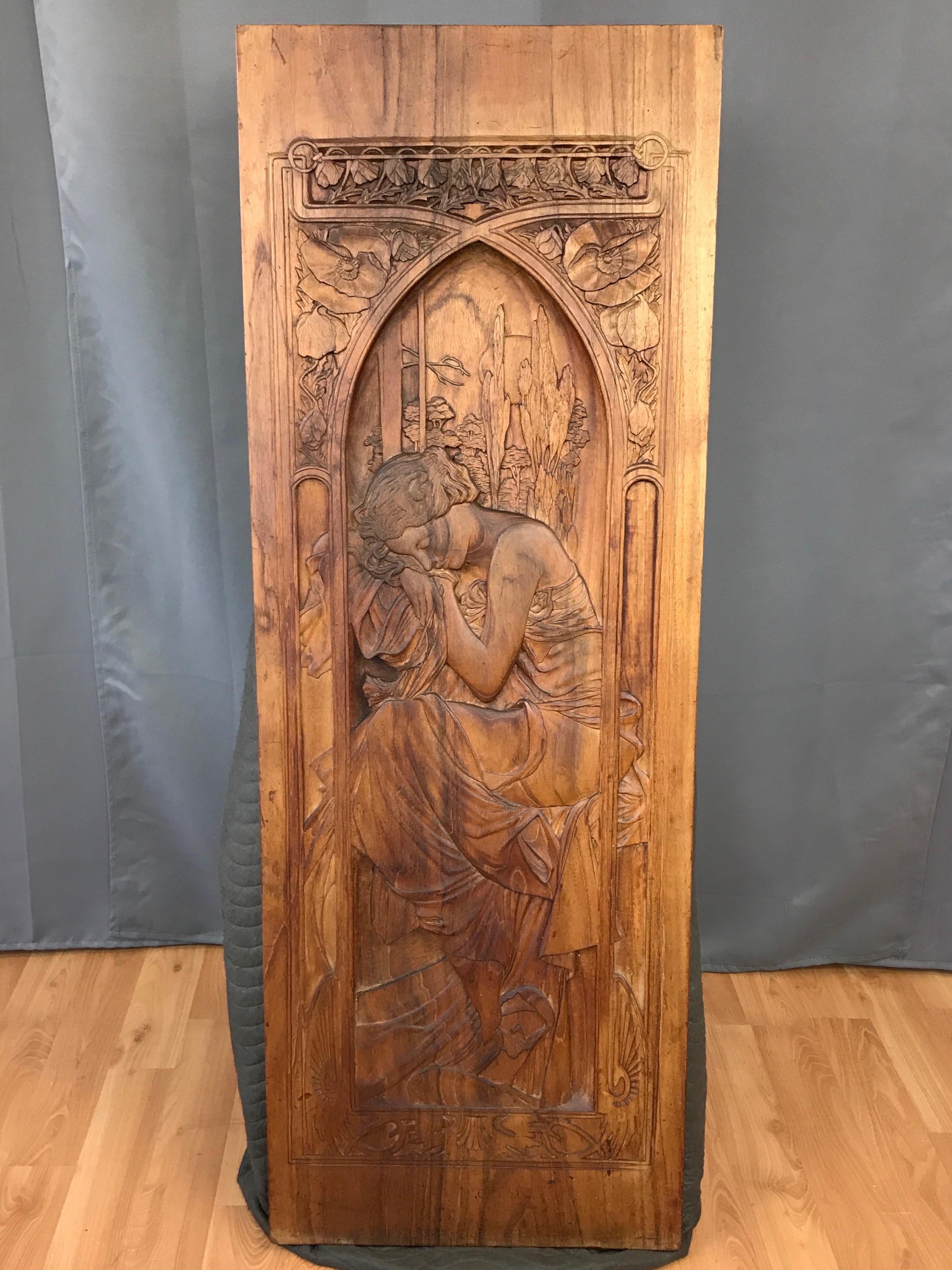 A substantial carved wood panel depicting iconic Art Nouveau artist Alphonse Mucha’s “Repos de la Nuit” from his 1899 series “The Times of the Day”.

Four-and-a-half foot-tall, nearly two inch-thick solid walnut plank with finely carved deep bas