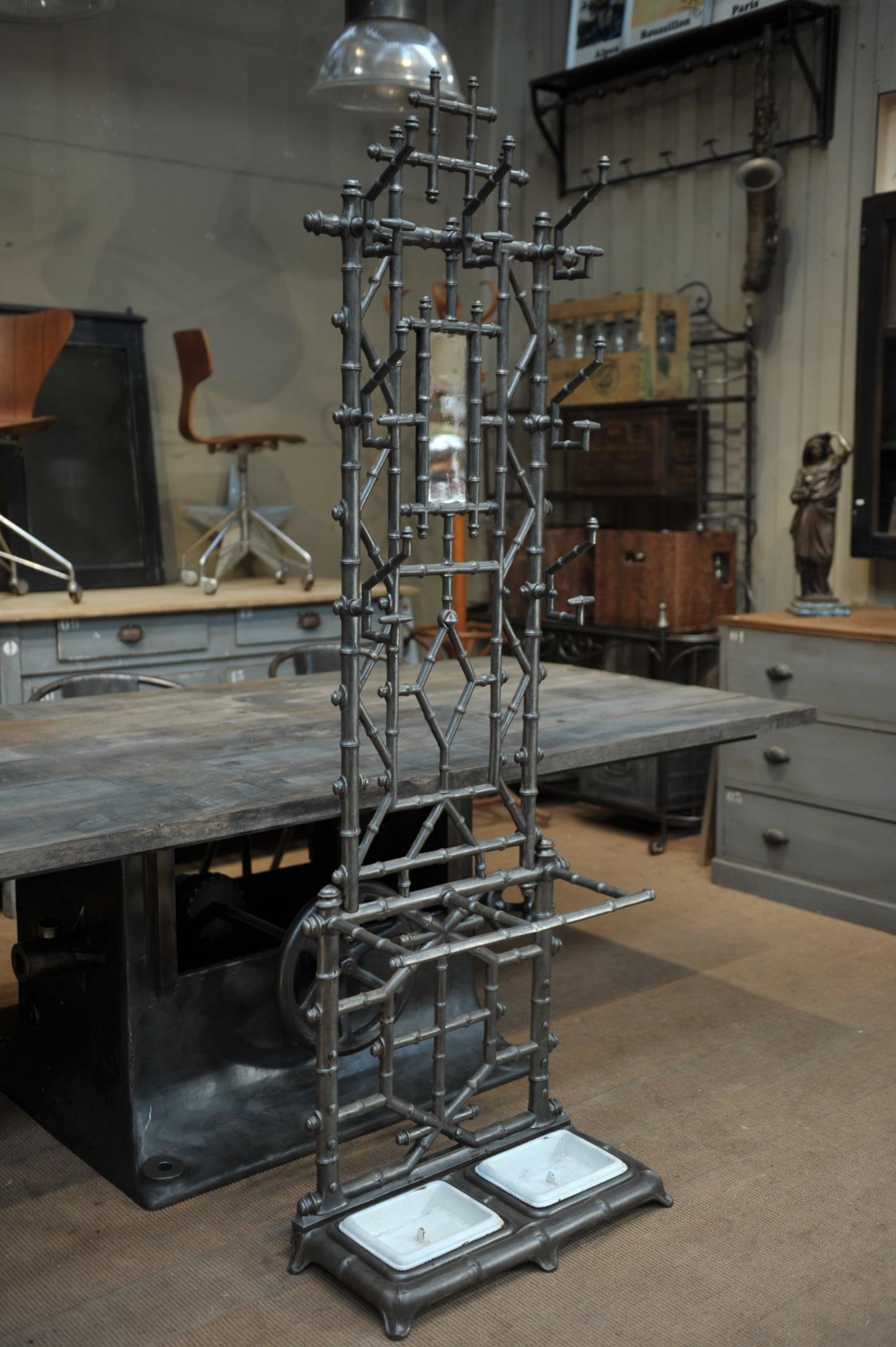 Art Nouveau polished cast iron coat rack with umbrella stand and it's original mirror. Very fine bamboo imitation typical from the French art nouveau style, circa 1890.