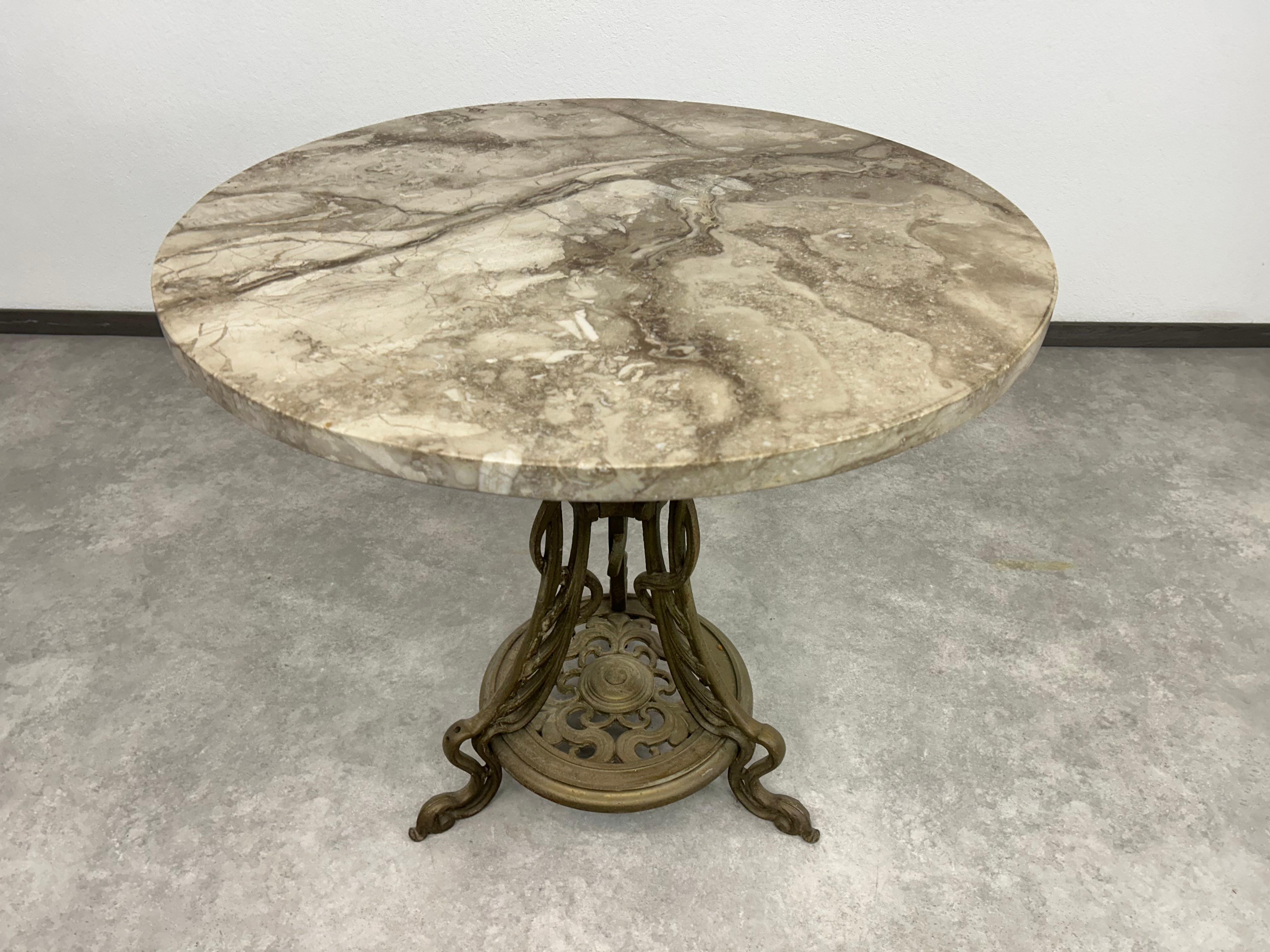 Art nouveau cast iron table with marble top in excellent original condition. 