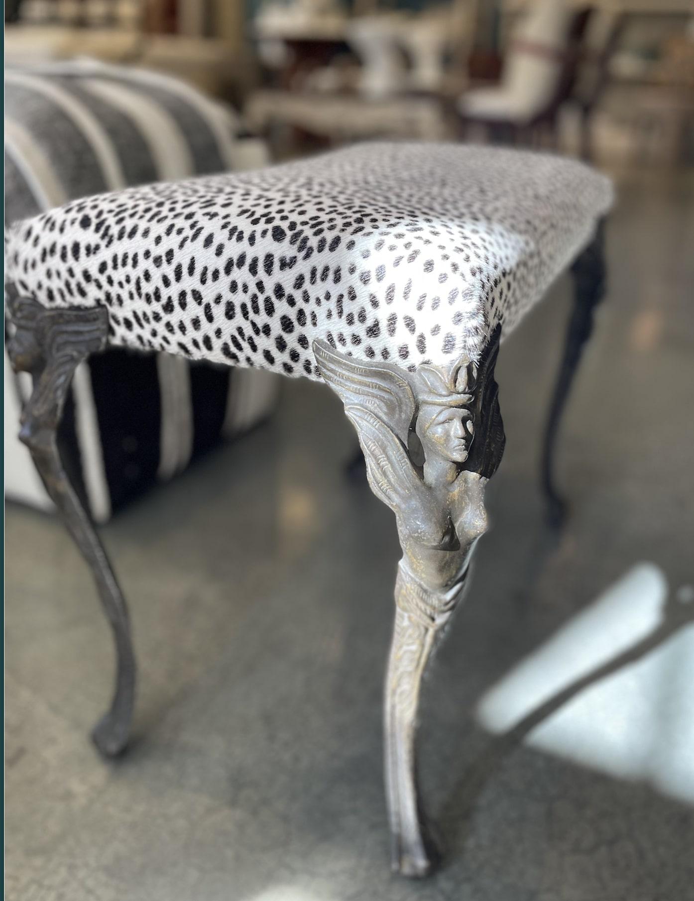 Antique Art Nouveau cast iron vanity bench with newly upholstered seat in a cool Cheetah printed hide. Legs are decorative cast iron winged female figures. What a a fun and sassy way accent to any bathroom or vanity table.

22