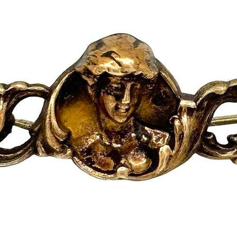 Art Nouveau Brass pin and pendant showcase a female cameo of a celestial nymph. The intricate design features delicate detailing, capturing the beauty of its feminine silhouette with graceful precision. Warm bronze tones enhance its vintage appeal,