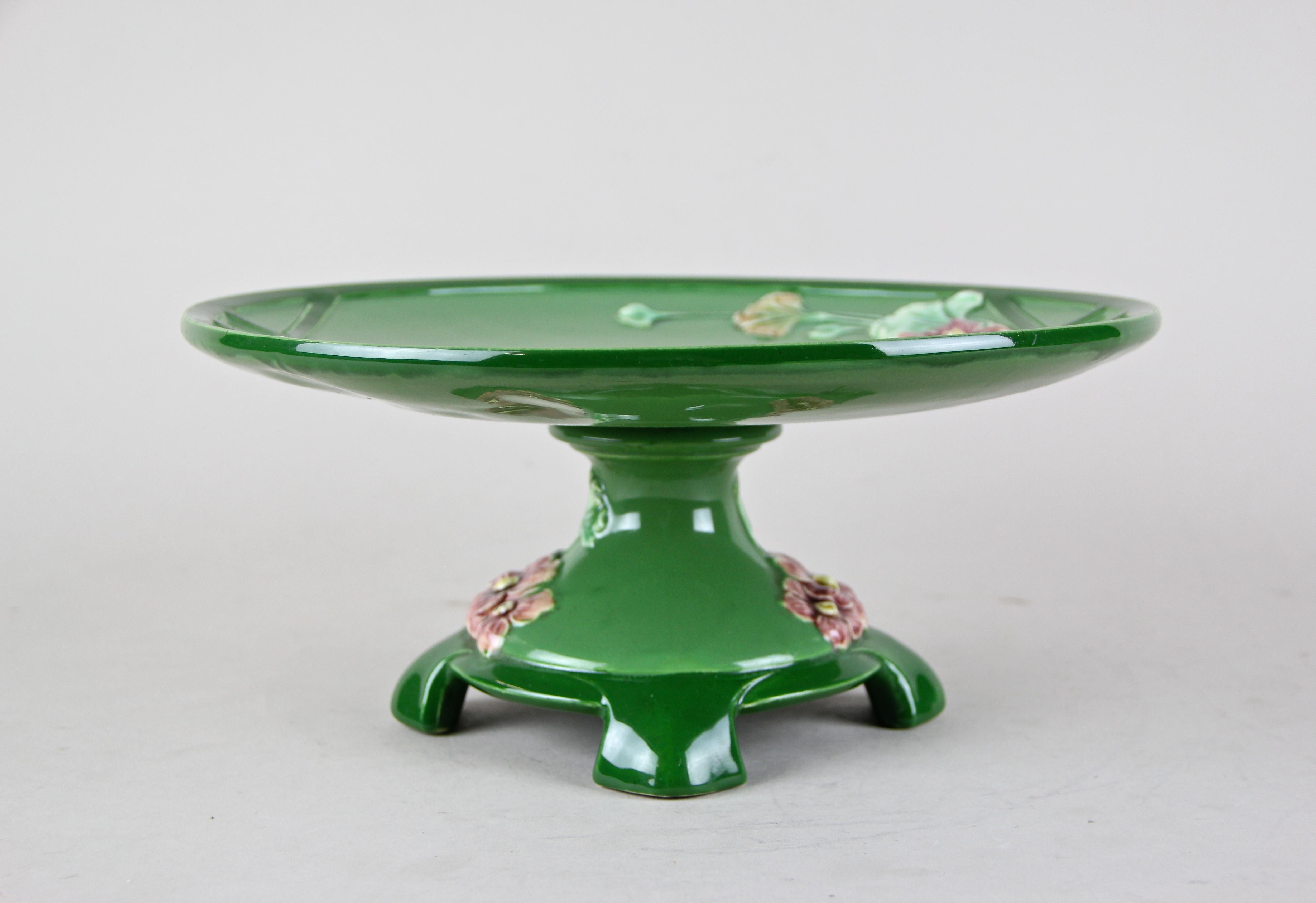 Another fine Art Nouveau centerpiece from the famous Majolica manufactory Eichwald circa 1910. The very own style of the coloration in green shades is typical for Eichwald. A round plate adorned by lovely blossoms sits on a nice shaped base with the