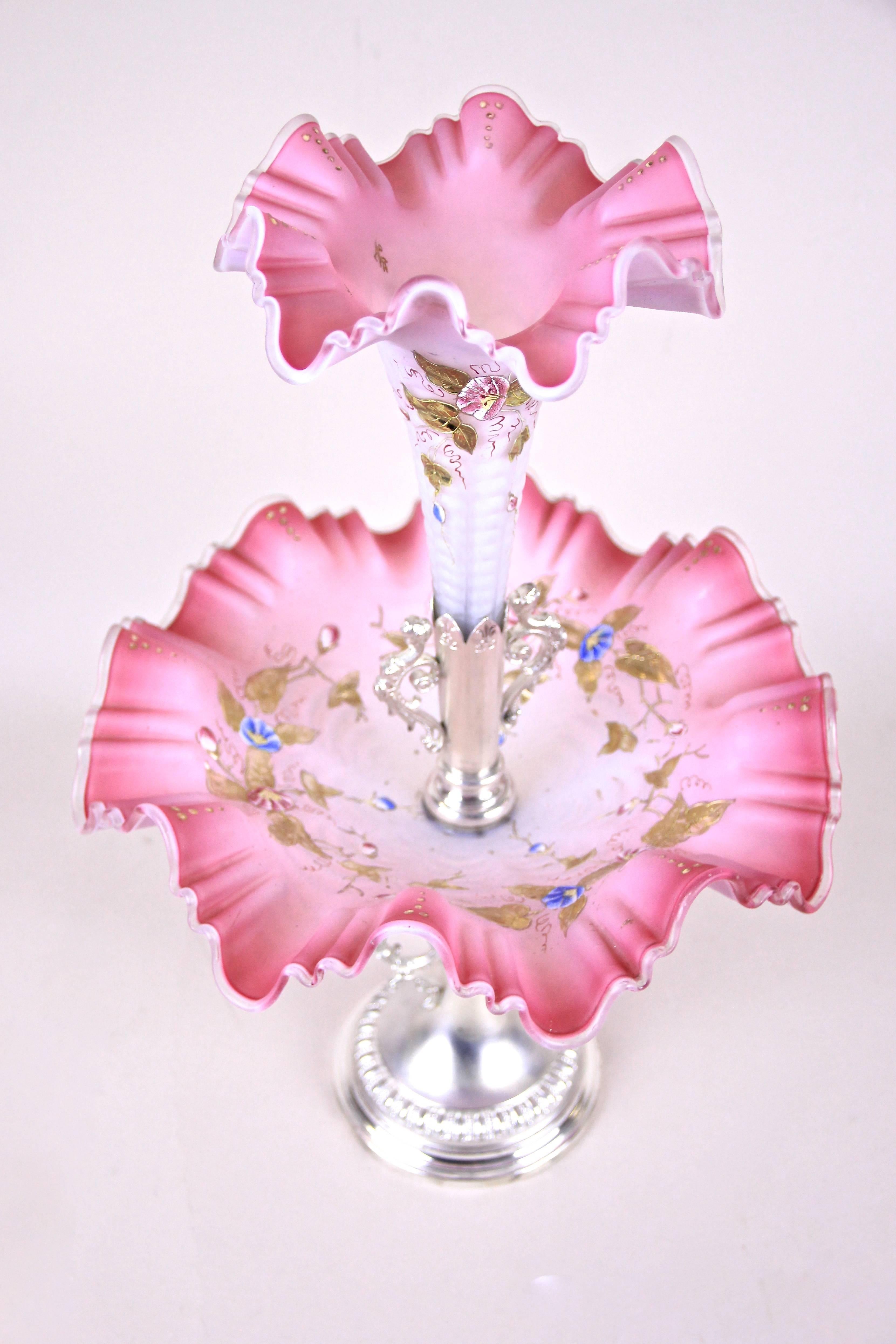 Charming Art Nouveau centrepiece made in Austria, circa 1900. A beautiful in pink tones shining mouth blown glass bowl sits on a metal - silver plated centrepiece with figural handles and shows an amazing enamel-painting that continues on the