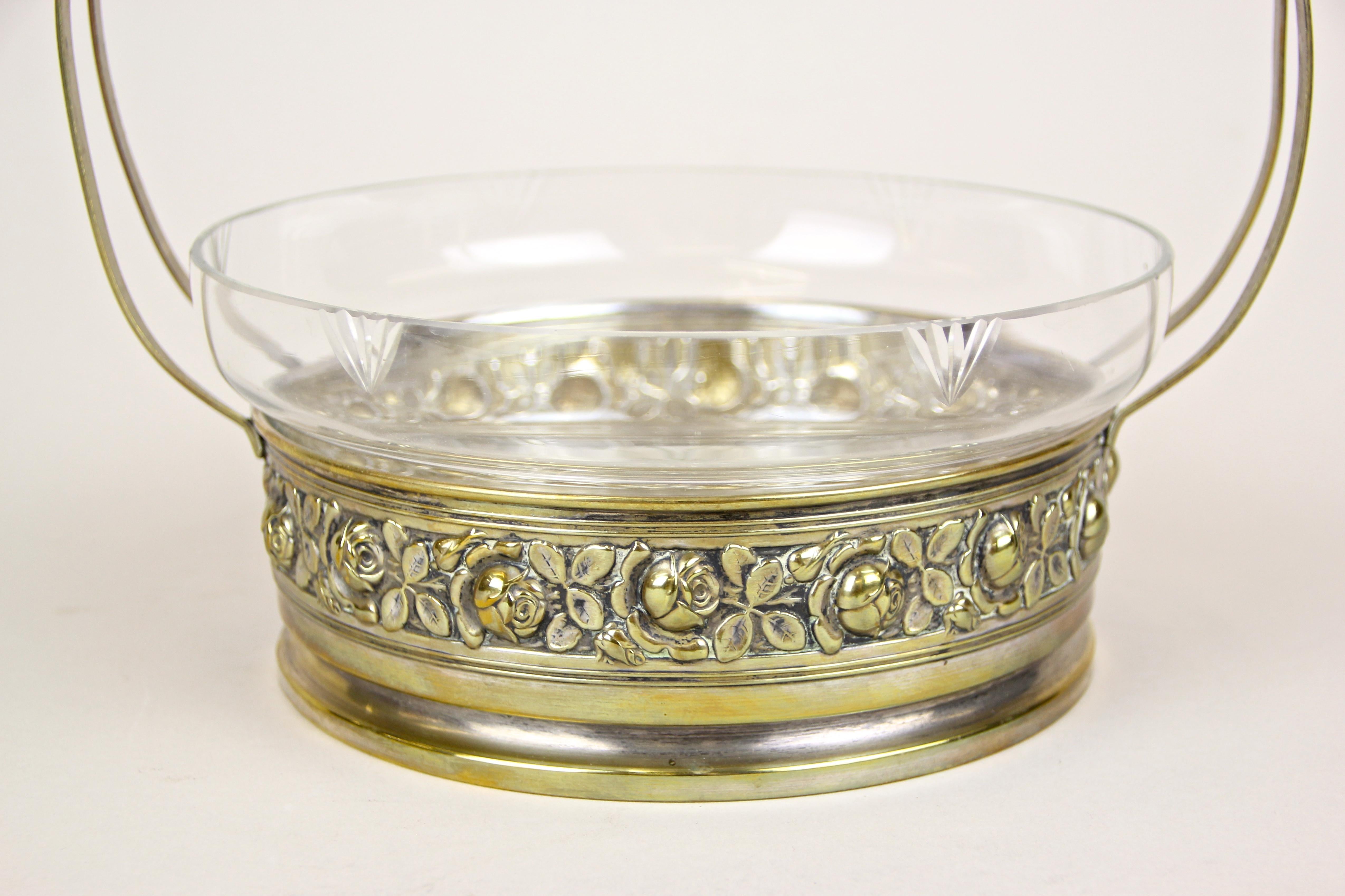 Very decorative Art Nouveau Centerpiece impressing with an inserted, engraved Glass Bowl in a Brass Basket processed in Austria around 1910. The delicate designed base shows the famous embossed viennese rose-design, made of fine brass. An artfully