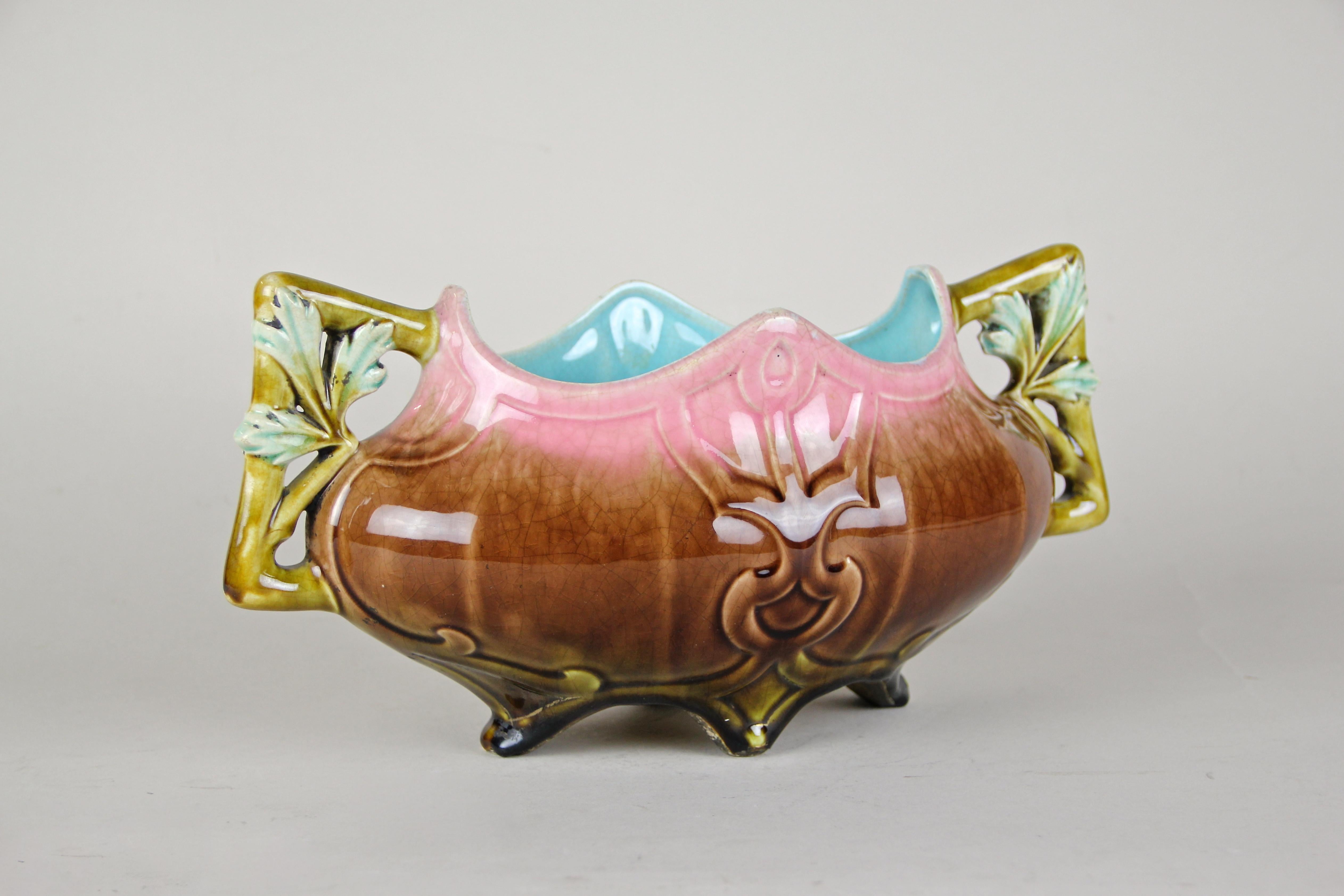 Delightful Art Nouveau ceramic jardinière out of France from the early period circa 1900. The unique shaped body of this French jardinière looks fantastic in combination with the lovely coloration in brown and pink. A highlight are the unusual