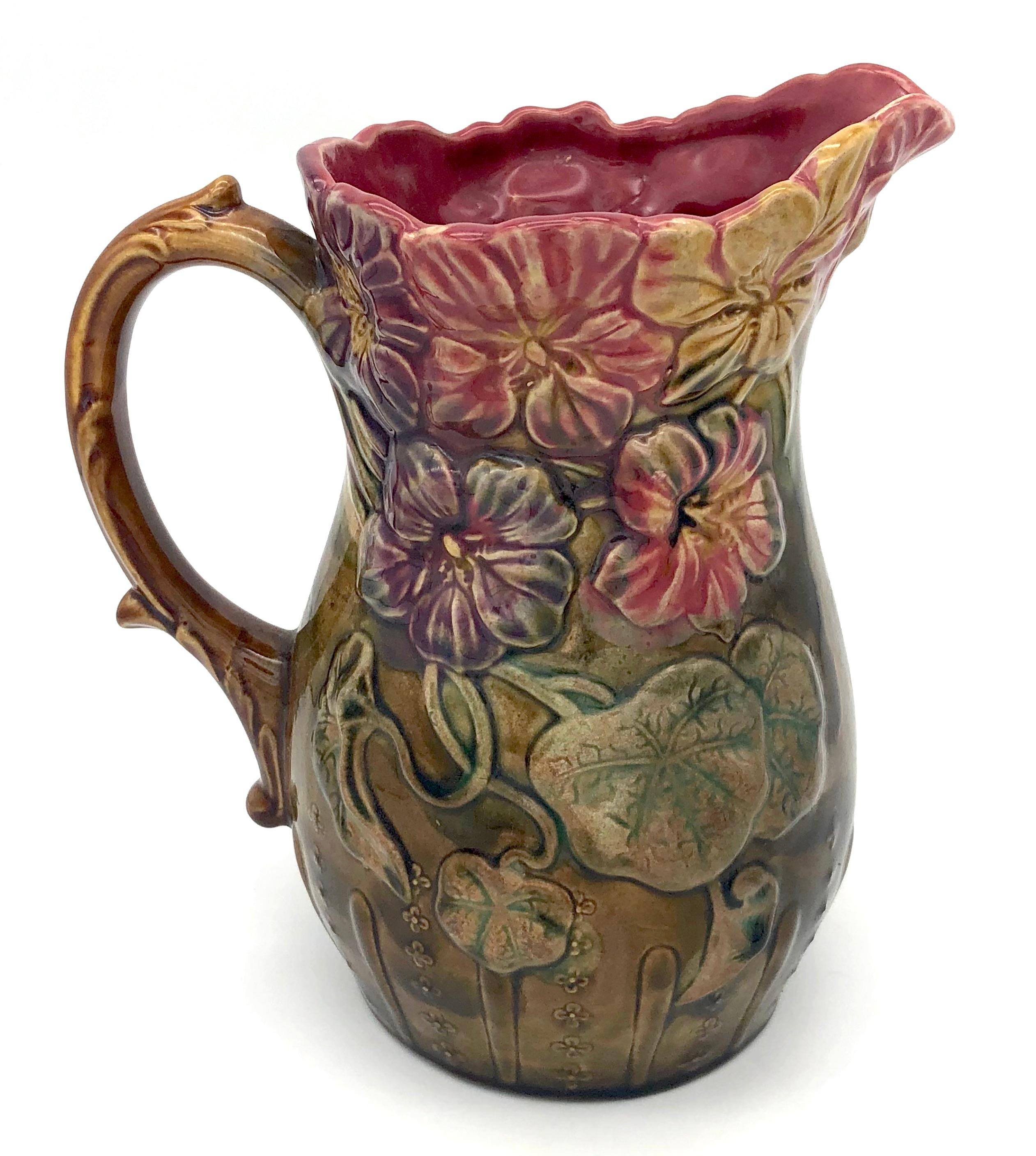 This wonderfully glazed pitcher is decorated with nasturtiums in relief.
It was handcrafted in France in 1895 ca.
The pitcher is marked Frie Onnaing, made in France.