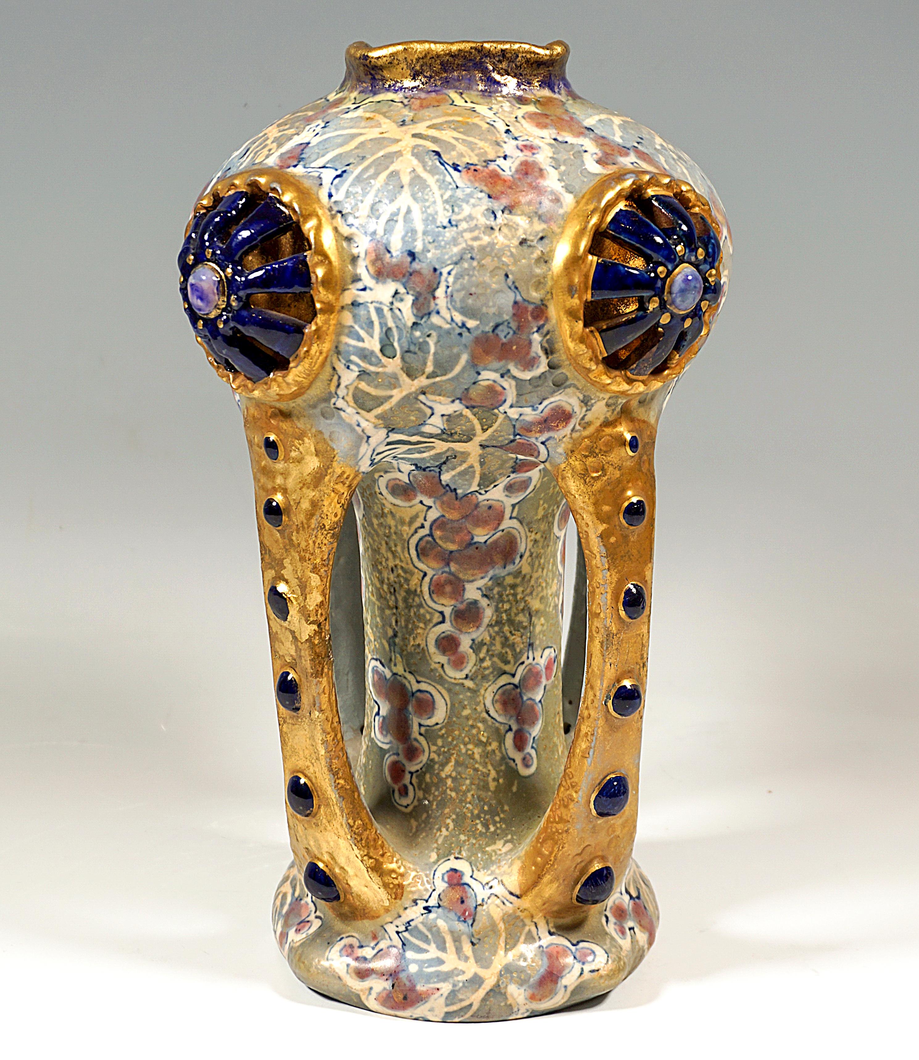 Excellent Art Nouveau Ceramic Piece:
Ceramic vase on a flush, flared, round foot with a slender neck and a large, bulbous head part with a small attached square opening, four bars emanating from the foot and connected to the head part enclose and