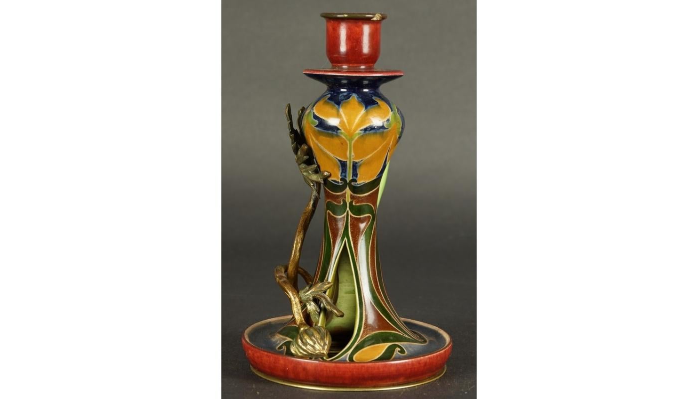 Art Nouveau ceramics and bronze candelabra Majolica circa 1900
Art Nouveau candlestick with a handle. The multicolored ceramics decoration, based on stylised floral motifs, has been supplemented with a metal application.
  