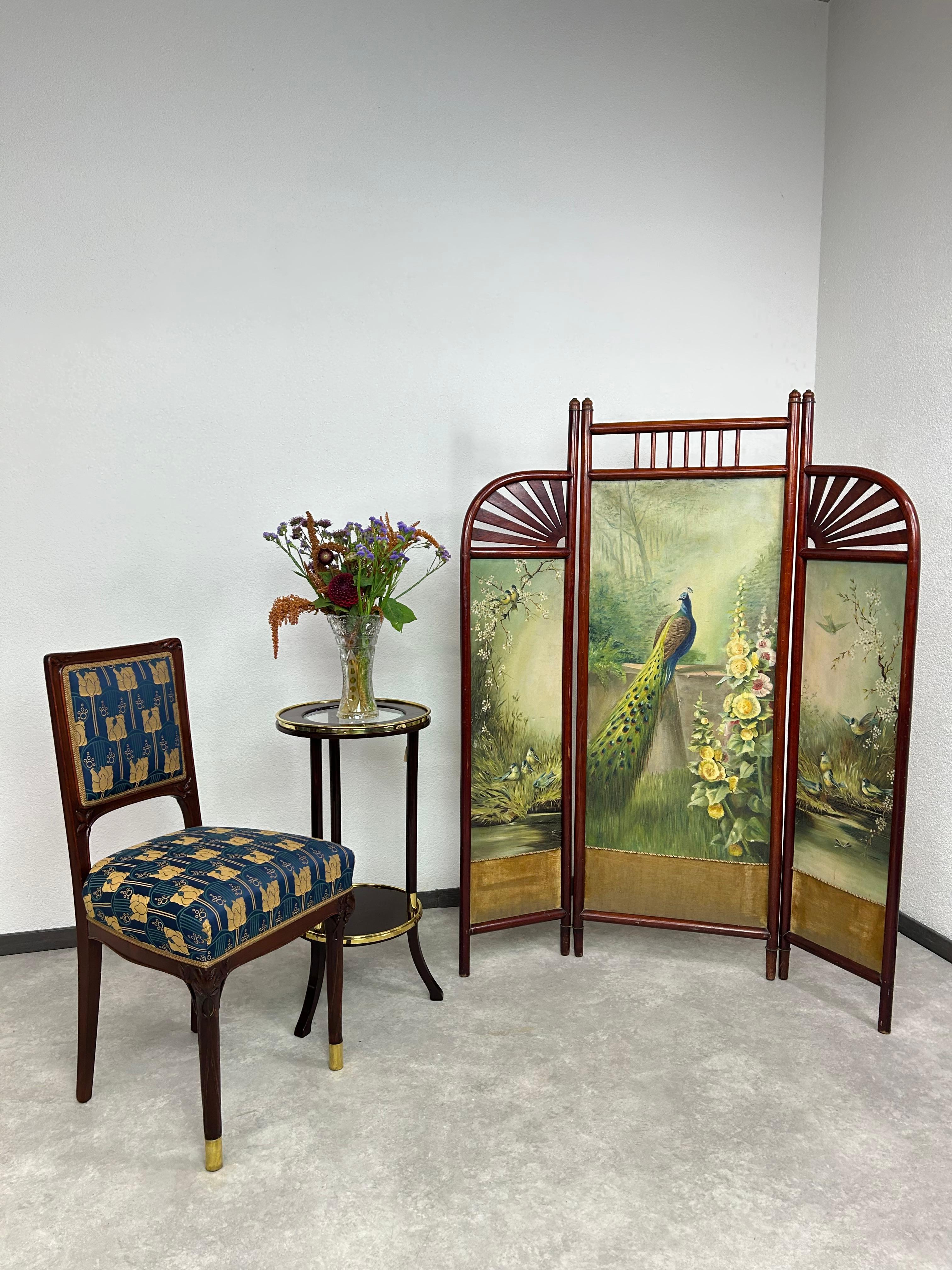 Art nouveau chair with floral motif and brass leg endings. Professionally stained and repolished with new fabric.
