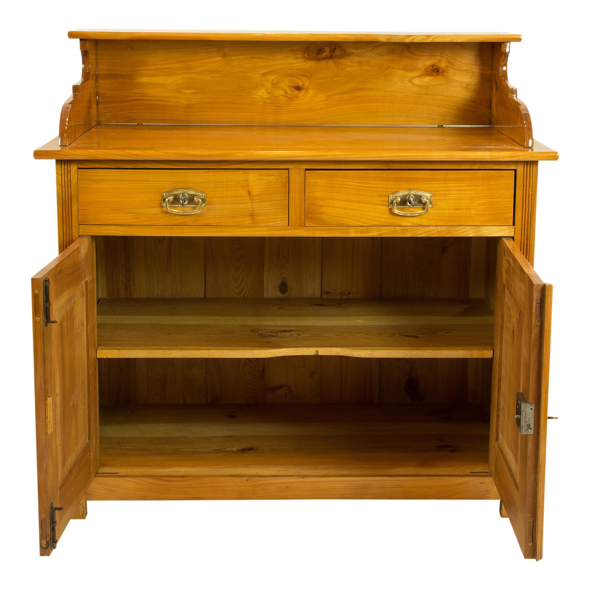 Beautiful simple half cupboard with doors and above it with two drawers as well as an attachment on top. The top is removable. The furniture was made of solid cherry wood and dates from the Art Nouveau period circa 1900.

Measures: Plate height