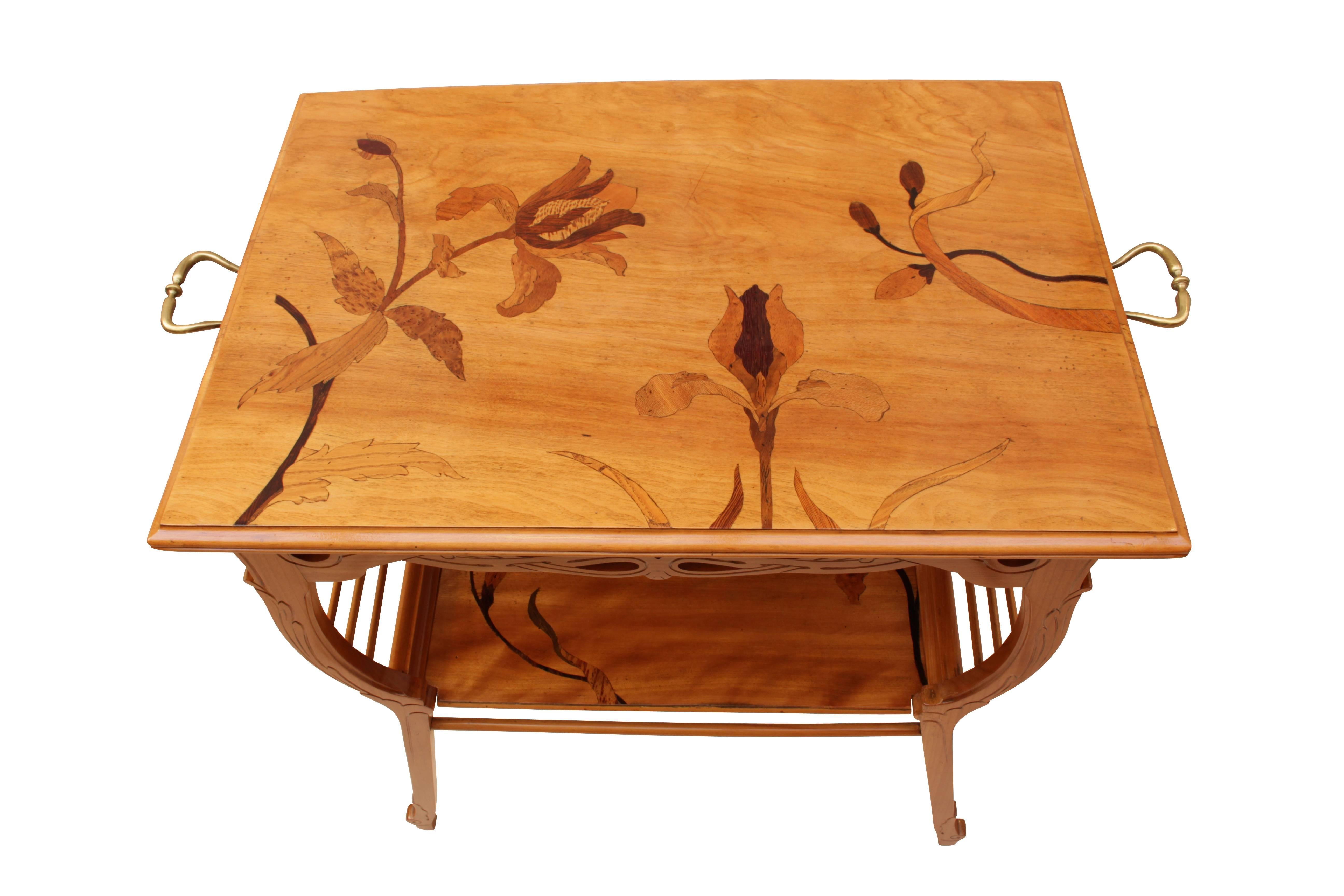 Very nice Art Nouveau side table from the period, circa 1900 from France. The delicate legs are made of cheerywood, the plates are veneered with walnut in which wonderful marquetry from different fruit trees are. On the sides are brass handles. The