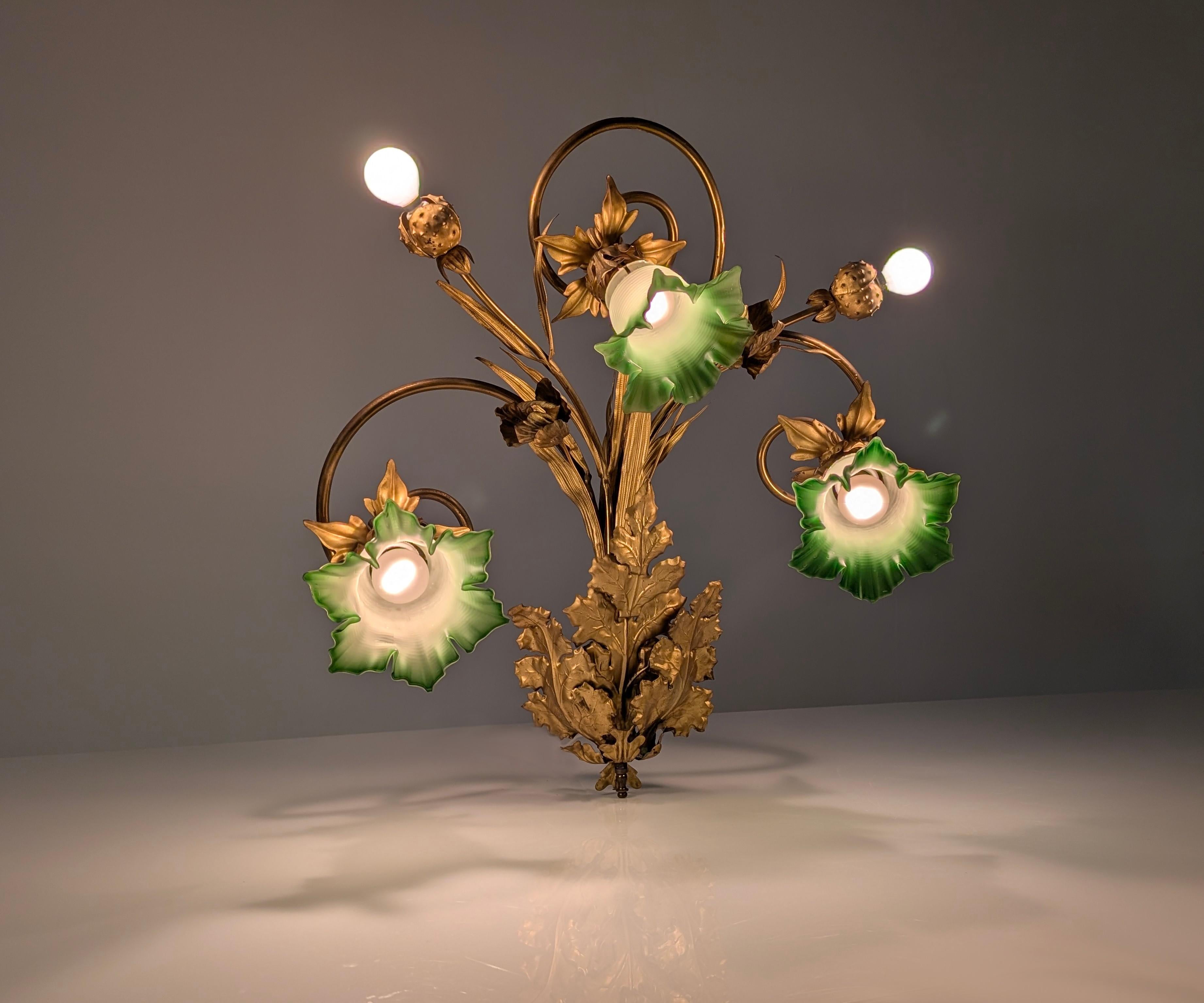 The essence of Art Nouveau is embodied in this exquisite gilt sconce, inspired by nature with chestnut leaves and two husks of its fruit that open to let both points of light sprout. A sculptural illumination showing an organic composition that is