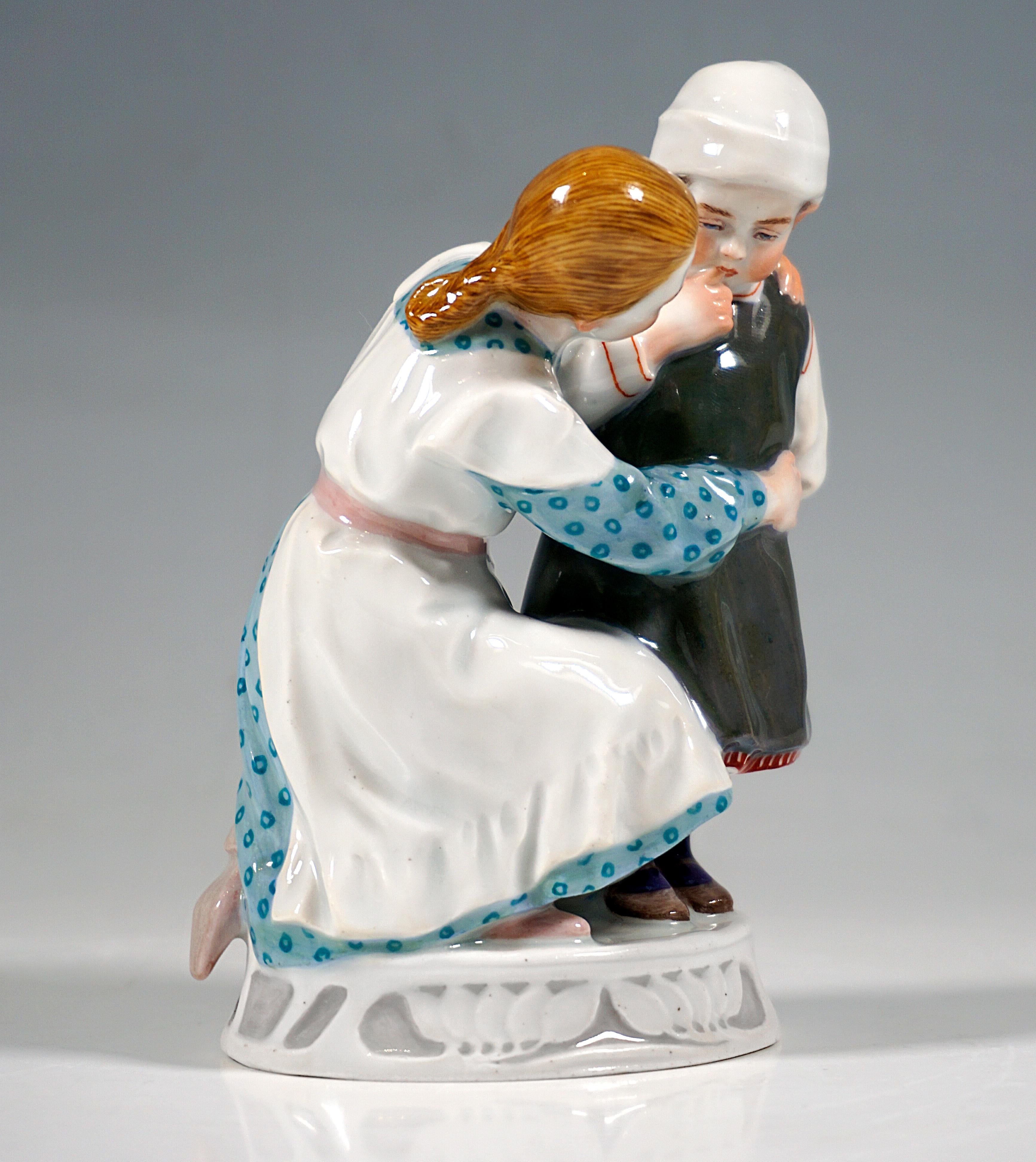 Extremely rare Meissen Art Nouveau porcelain group:
Girl and child in clothes from around 1900, the girl in a blue, polka-dot long-sleeved dress with a white apron kneeling on the floor and hugging and comforting a small standing child in a