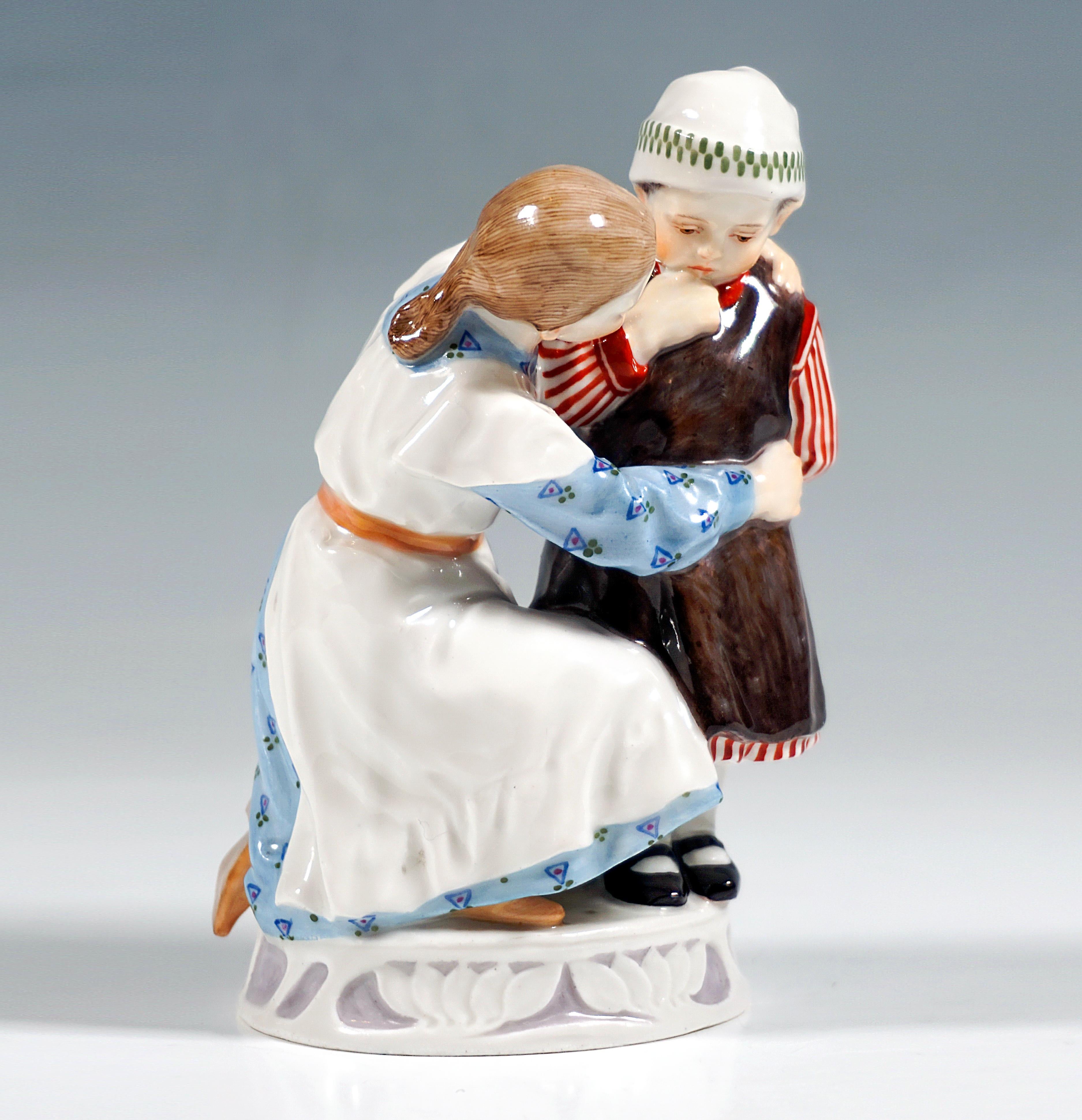 Very rare Meissen Art Nouveau porcelain figure group:
Girl and child in clothing from around 1900, the girl in a blue patterned long-sleeved dress with a white apron kneeling on the floor and a small standing child in a white and red striped dress