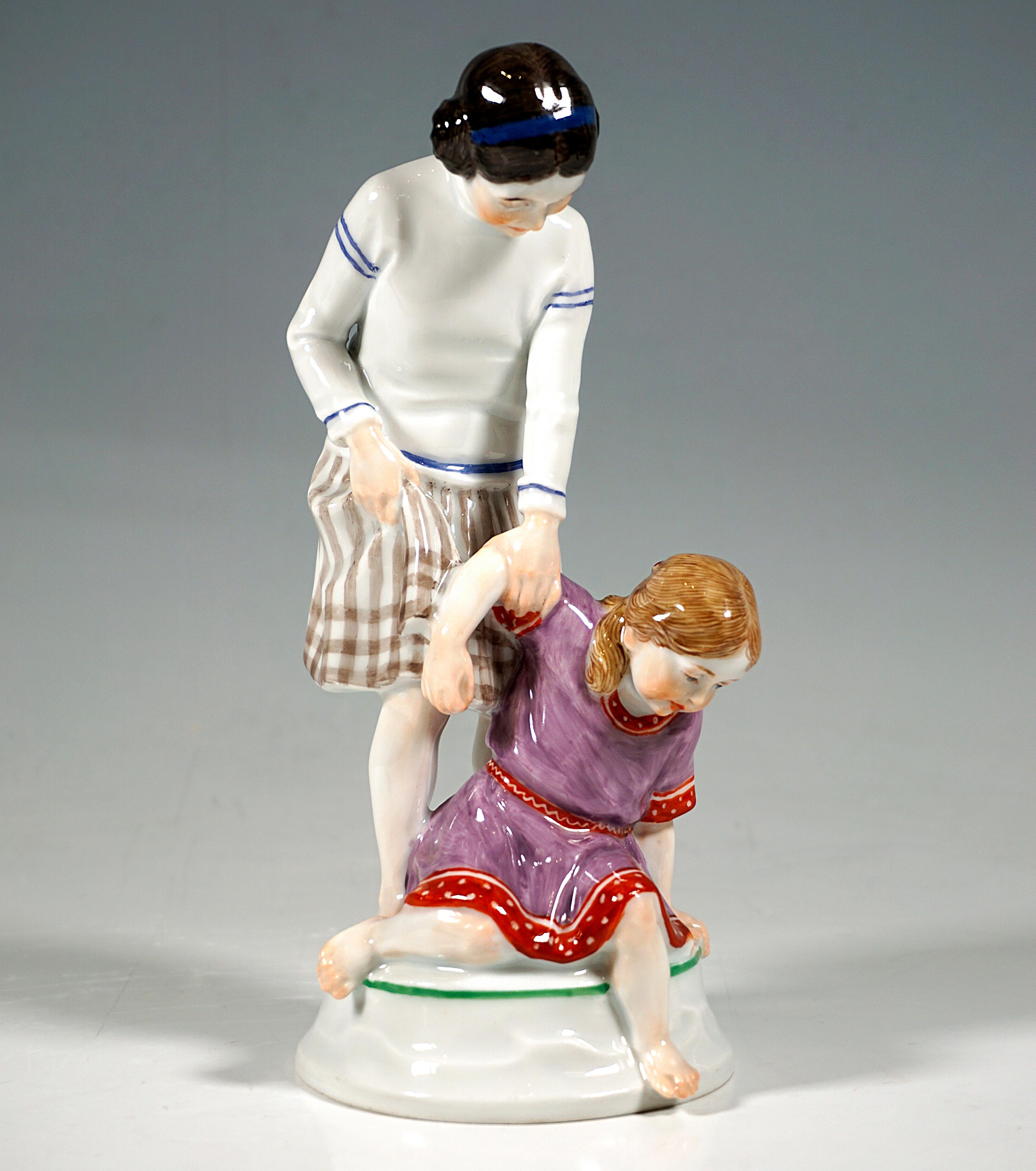 Extremely rare Meissen Art Nouveau porcelain group:
Two barefoot girls in summer clothes, the older one in a striped skirt and white and blue long-sleeved bodice, her hair pinned up in two side buns, grabbing the arm of the younger child in a red
