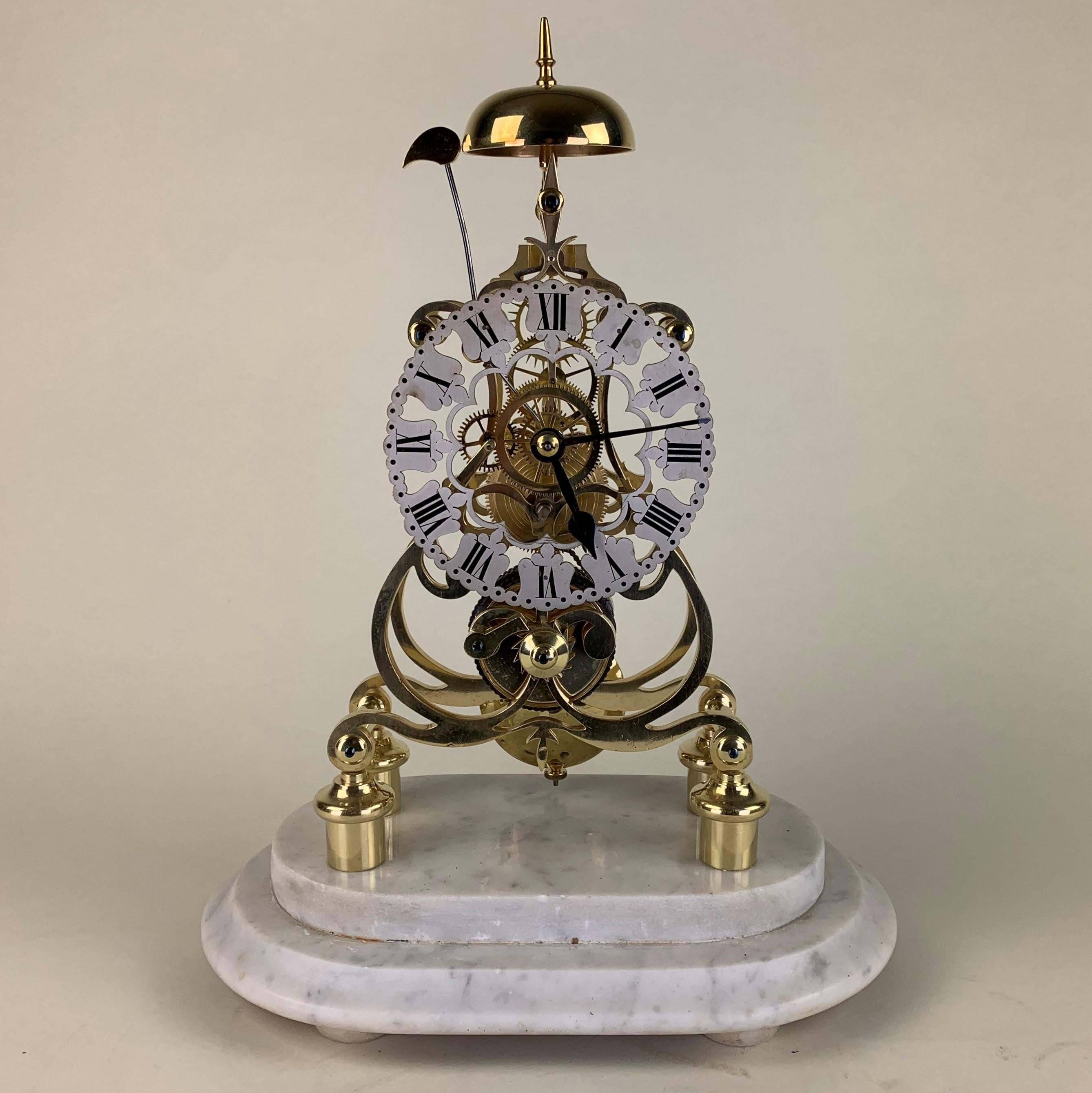 A fine quality Art Nouveau, steeple shaped skeleton clock raised on four pillars with a chain driven movement surmounted by a bell chiming the hours. Pierced silvered chapter ring with Roman numerals. Housed under its original glass dome and white