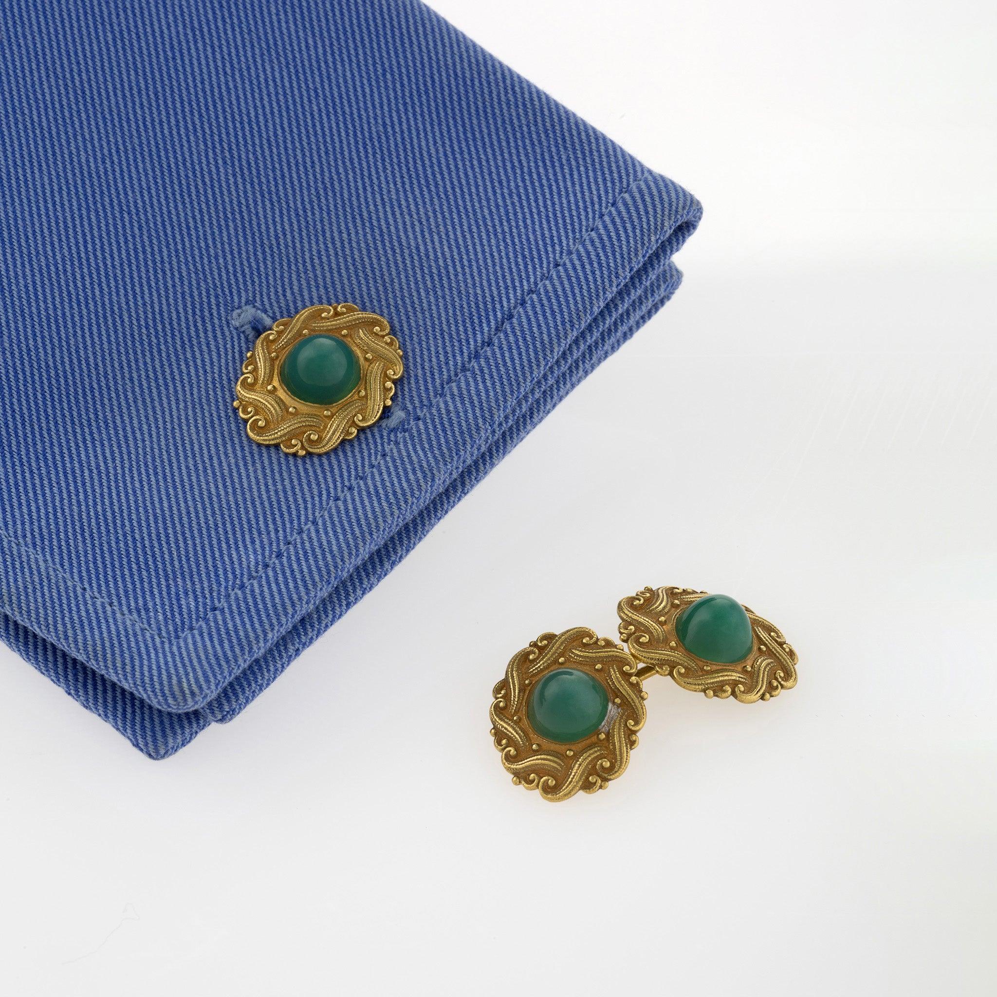These European Art Nouveau 18K gold chrysoprase or green chalcedony cuff links  date from c. 1900. They are designed as double oval links, each set with a sugar loaf chrysoprase cabochon within a polished, chased and engraved surround of