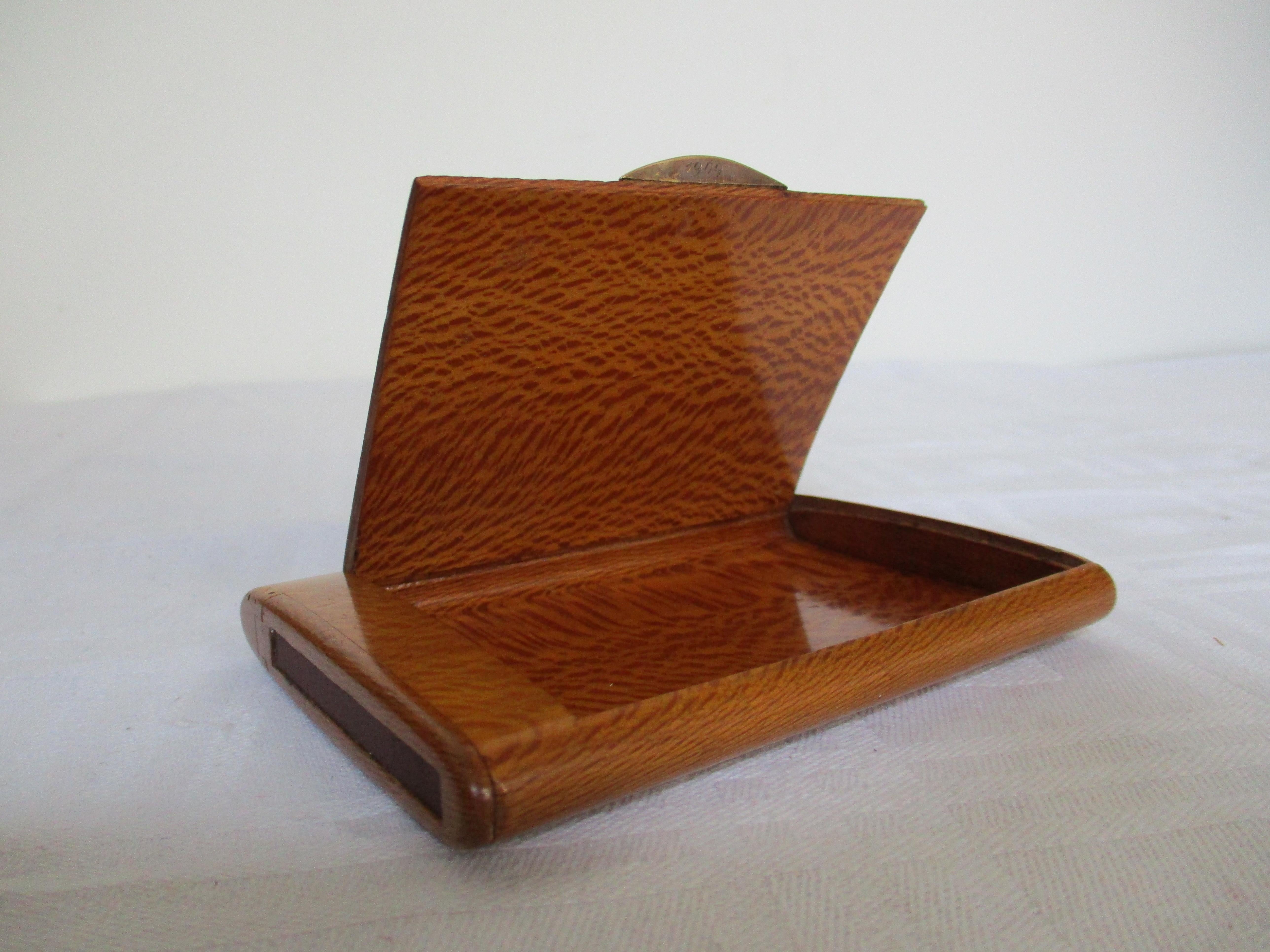 Beautiful wooden cigarette box with 14 carat solid gold handle with a sapphire. Line on the side to light up matches. 