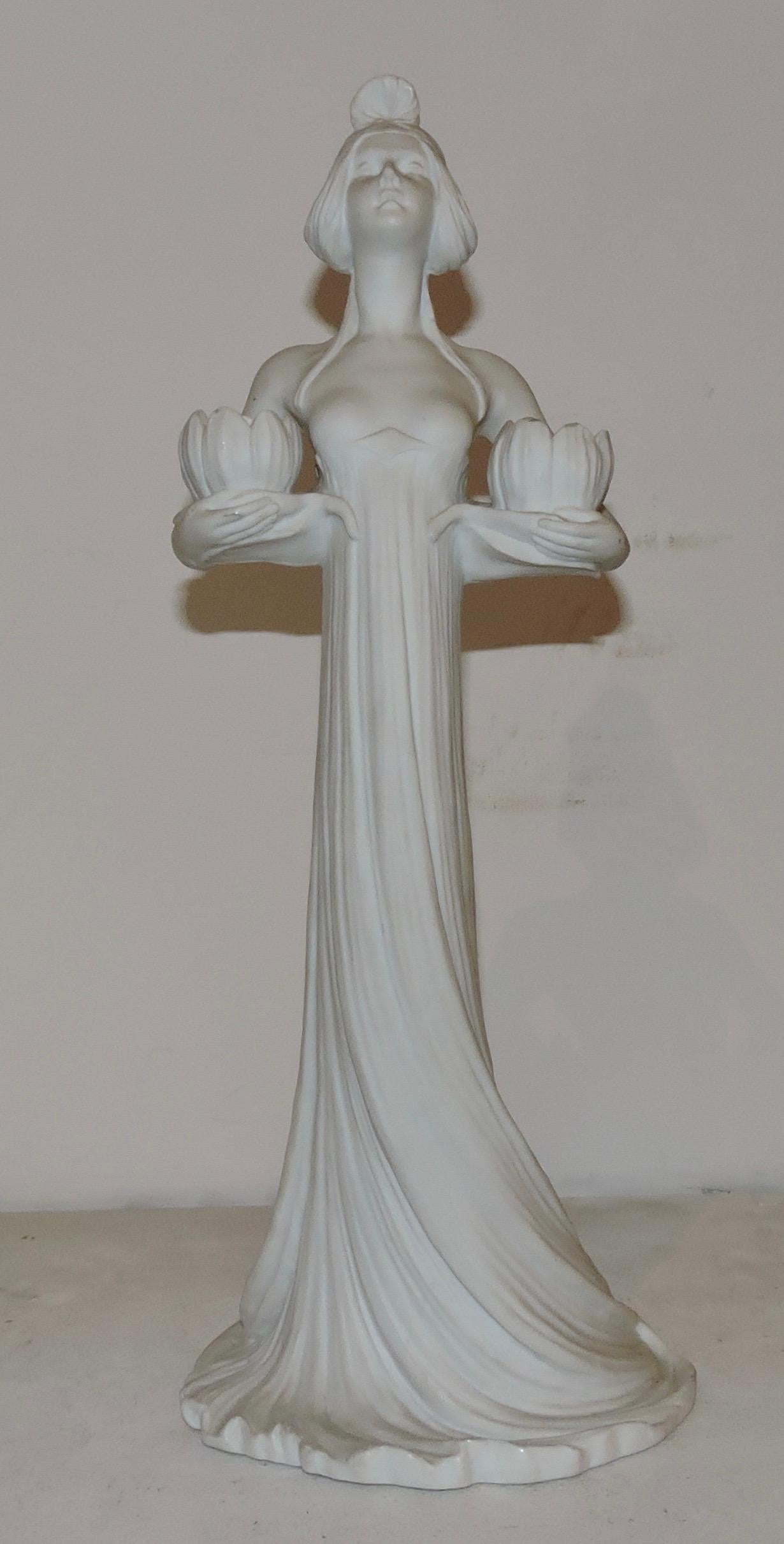 An Art Nouveau circa 1900 biscuit porcelain two-lights candelabra
Designed as a Fairy Woman, the two-lights figuring Waterlilies Flowers
Impressed mark under the base 