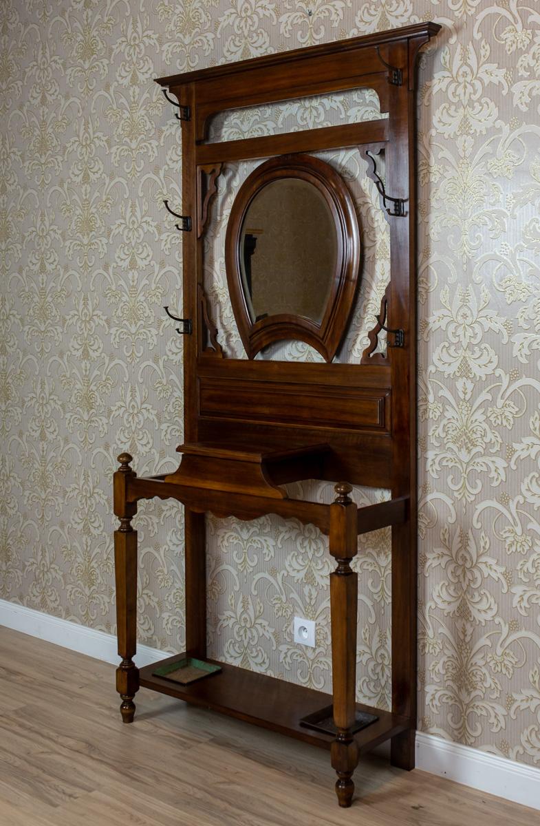 We present you a closet, circa 1900-1910, made of mahogany wood.
This piece of furniture is in the form of an openwork wall with an advanced base for umbrellas and a storage compartment for brushes and shoe polish.
The upper section has a mirror