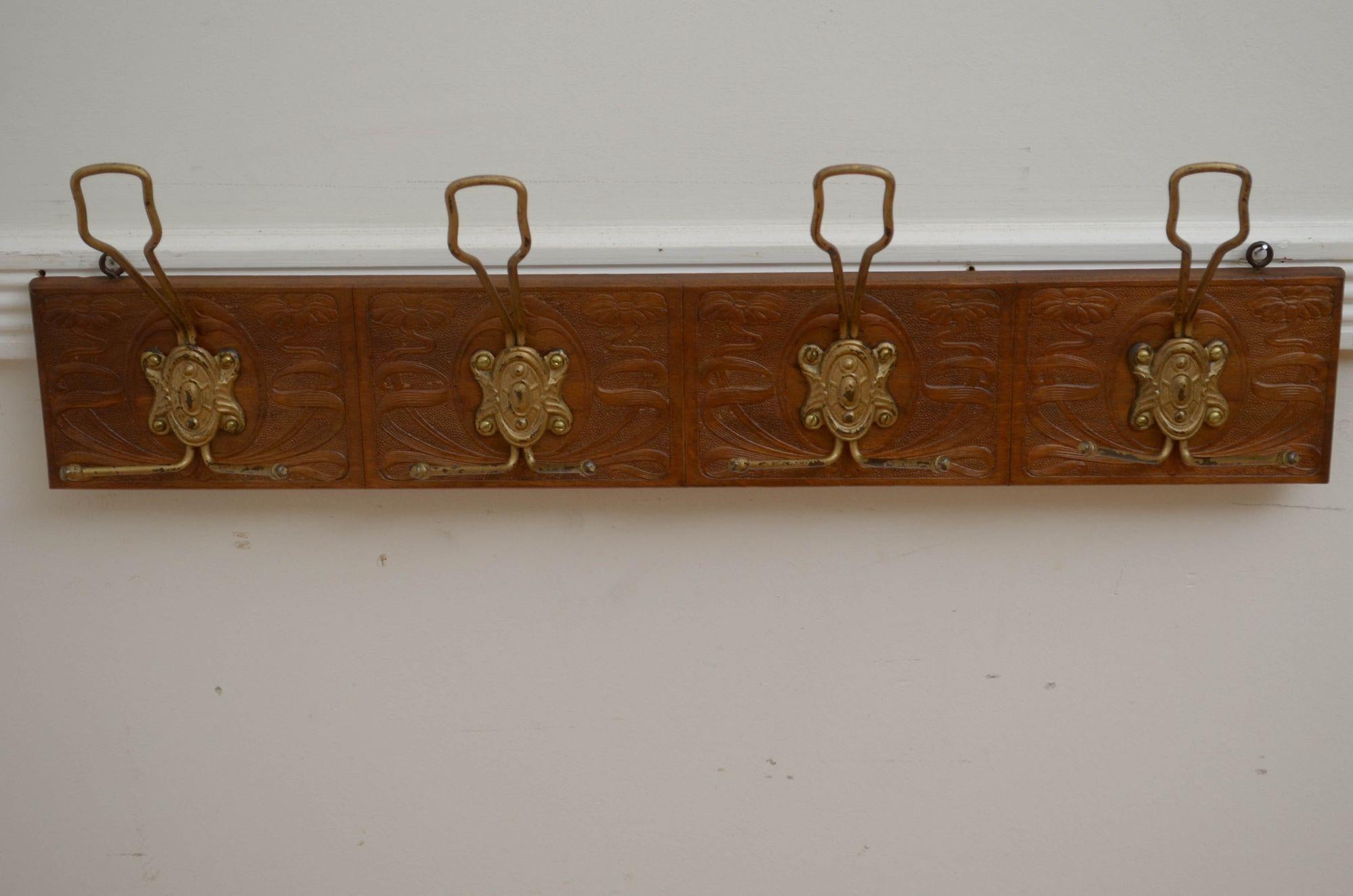 P0283 Very attractive Art Nouveau coat rack, having four triple hooks with decorative backplates on finely carved with floral motifs walnut backing, all in home ready condition. c1900
H8